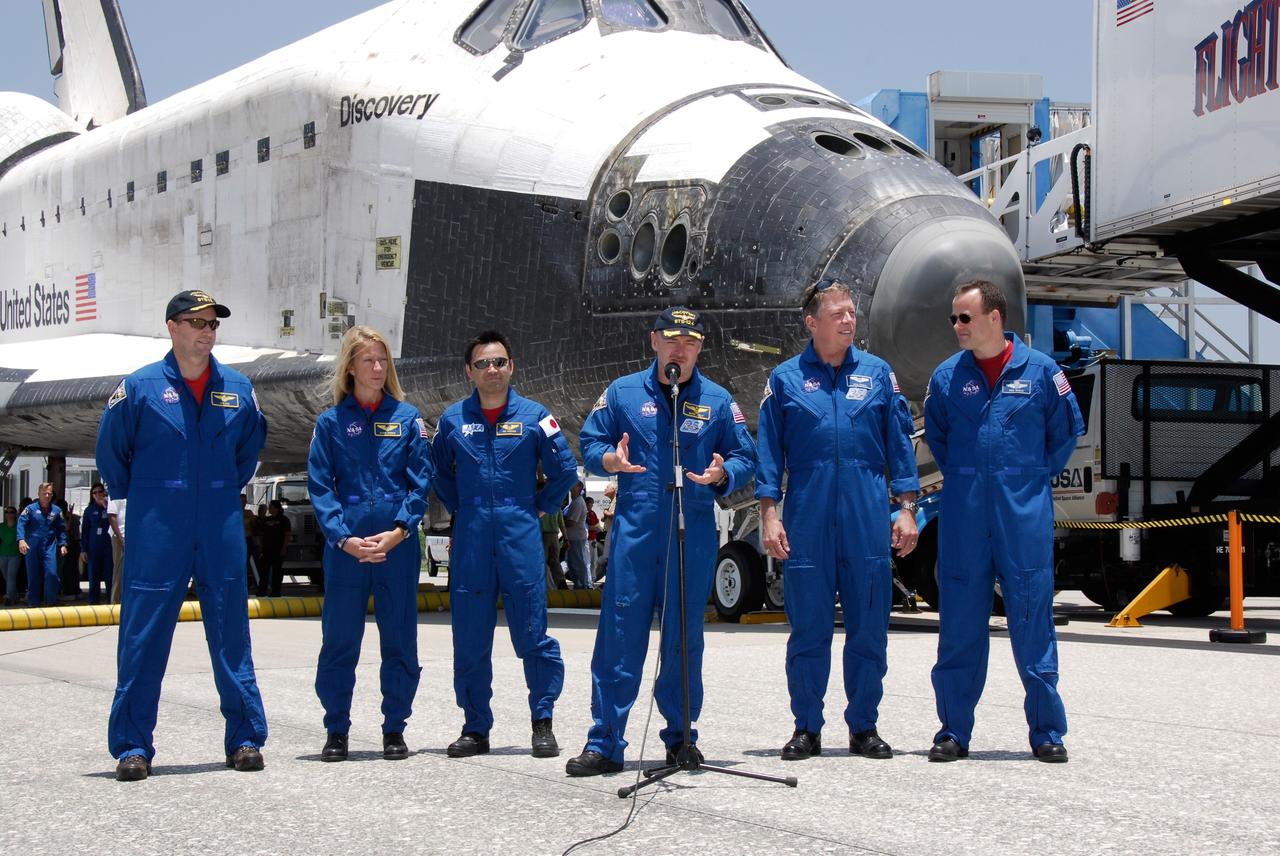 CAPE CANAVERAL, Fla. – The STS-124 mission crew addresses the media after their successful landing aboard space shuttle Discovery on Runway 15 at NASA's Kennedy Space Center. The landing ended a 14-day mission to the International Space Station. From left are Pilot Ken Ham, Mission Specialists Karen Nyberg and Akihiko Hoshide, Commander Mark Kelly, and Mission Specialists Mike Fossum and Ron Garan. Discovery's main landing gear touched down at 11:15:19 a.m. EDT on Runway 15. The nose landing gear touched down at 11:15:30 a.m. and wheel stop was at 11:16:19 a.m. The mission completed 5.7 million miles. The STS-124 mission delivered the Japan Aerospace Exploration Agency's large Japanese Pressurized Module and its remote manipulator system to the space station. Photo credit: NASA/Kim Shiflett