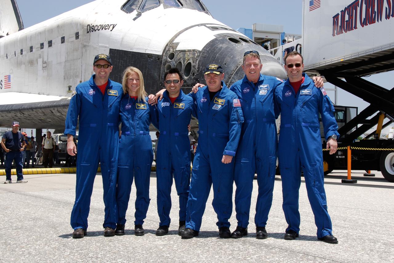 CAPE CANAVERAL, Fla. – The STS-124 mission crew pose for a final group photo before heading to crew quarters after their successful landing aboard space shuttle Discovery on Runway 15 at NASA's Kennedy Space Center. The landing ended a 14-day mission to the International Space Station. From left are Pilot Ken Ham, Mission Specialists Karen Nyberg and Akihiko Hoshide, Commander Mark Kelly, and Mission Specialists Mike Fossum and Ron Garan. Discovery's main landing gear touched down at 11:15:19 a.m. EDT. The nose landing gear touched down at 11:15:30 a.m. and wheel stop was at 11:16:19 a.m. The mission completed 5.7 million miles. The STS-124 mission delivered the Japan Aerospace Exploration Agency's large Japanese Pressurized Module and its remote manipulator system to the space station. Photo credit: NASA/Kim Shiflett
