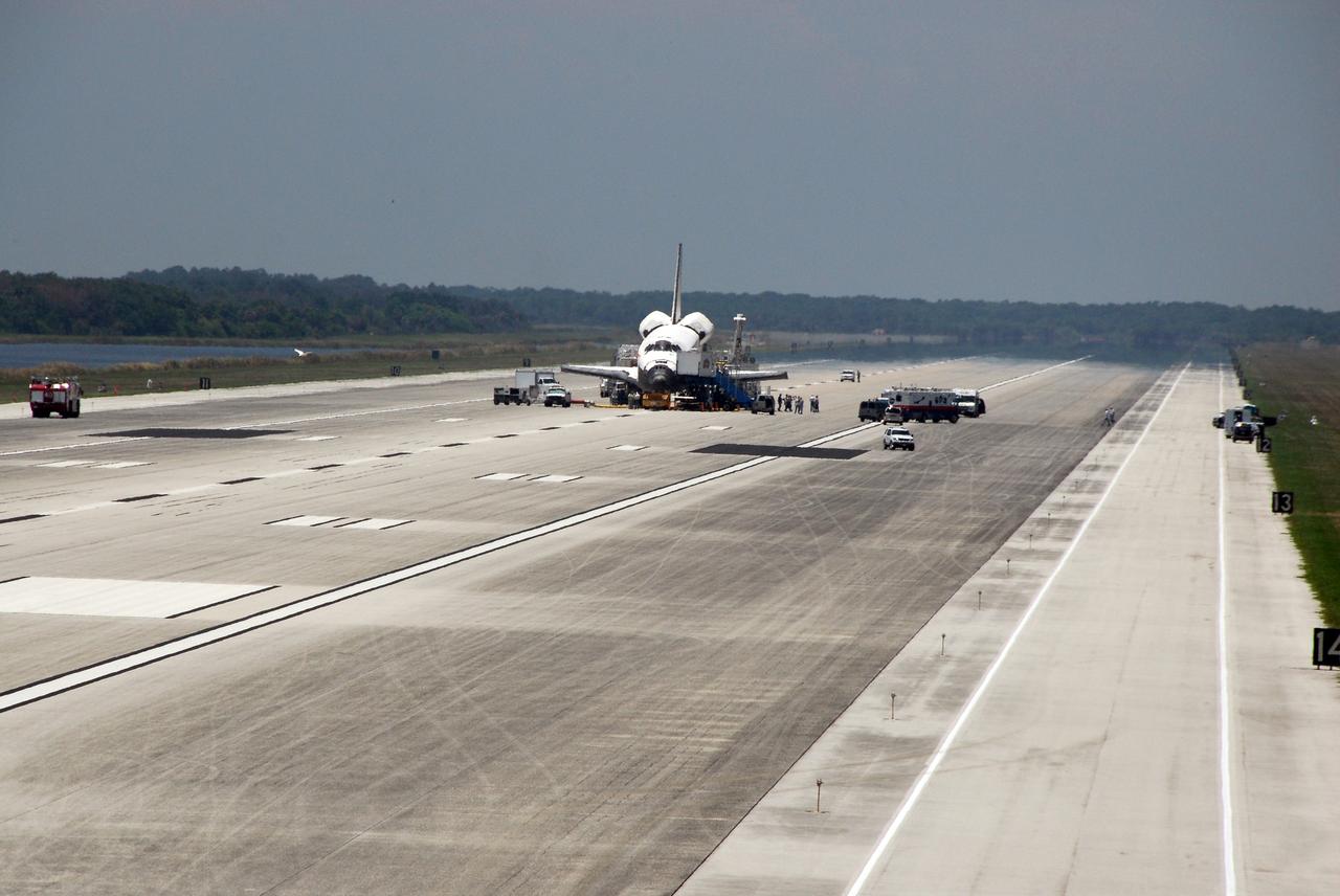 CAPE CANAVERAL, Fla.  –  A crew transport vehicle, or CTV, approaches space shuttle Discovery on the Shuttle Landing Facility at NASA's Kennedy Space Center.  Discovery landed on Runway 15, ending the 14-day, STS-124 mission to the International Space Station.   Discovery has been purged -- providing cool and humidified air conditioning to the payload bay and other cavities to remove any residual explosive or toxic fumes – while still on the runway. Cooling transfer to ground services occurs at about the same time, allowing onboard cooling to be shut down. When it is determined that the area in and around the orbiter is safe, the crew will departure from the orbiter to the CTV. The STS-124 mission delivered the Japan Aerospace Exploration Agency's large Japanese Pressurized Module and its remote manipulator system to the space station.  Photo credit: NASA/Kim Shiflett