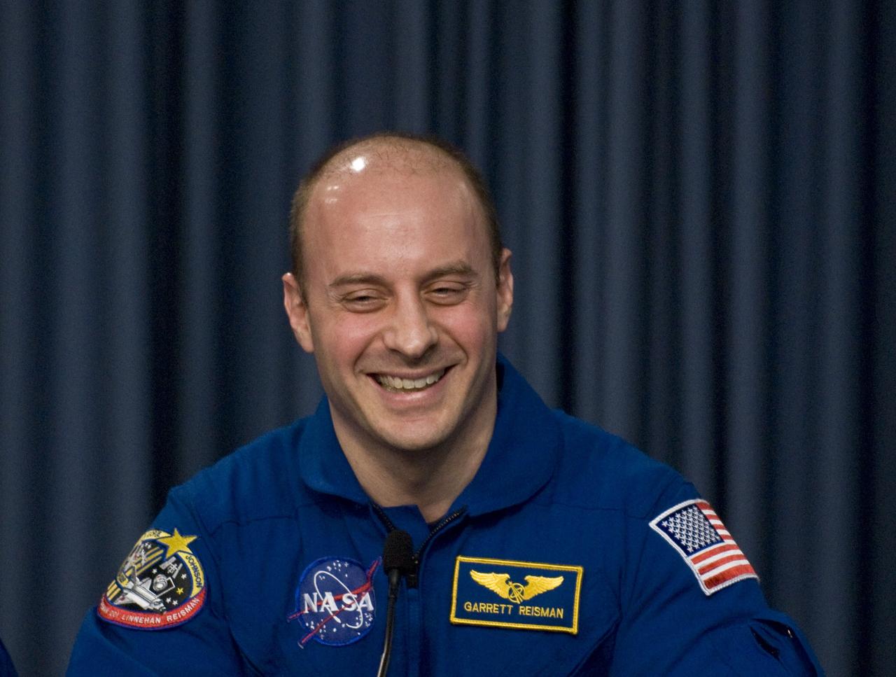 CAPE CANAVERAL, Fla. – Following the successful landing of space shuttle Discovery at NASA's Kennedy Space Center to end the 14-day, STS-124 mission, the crew sits for a press conference. Astronaut Garrett Reisman, who returned to Earth on Discovery after a 95-day stay on the International Space Station, talks about his delight at the Florida sunshine. The STS-124 mission delivered the Japan Aerospace Exploration Agency's large Japanese Pressurized Module and its remote manipulator system to the International Space Station. The landing was on time at 11:15 a.m. EDT. Photo credit: NASA/Kim Shiflett