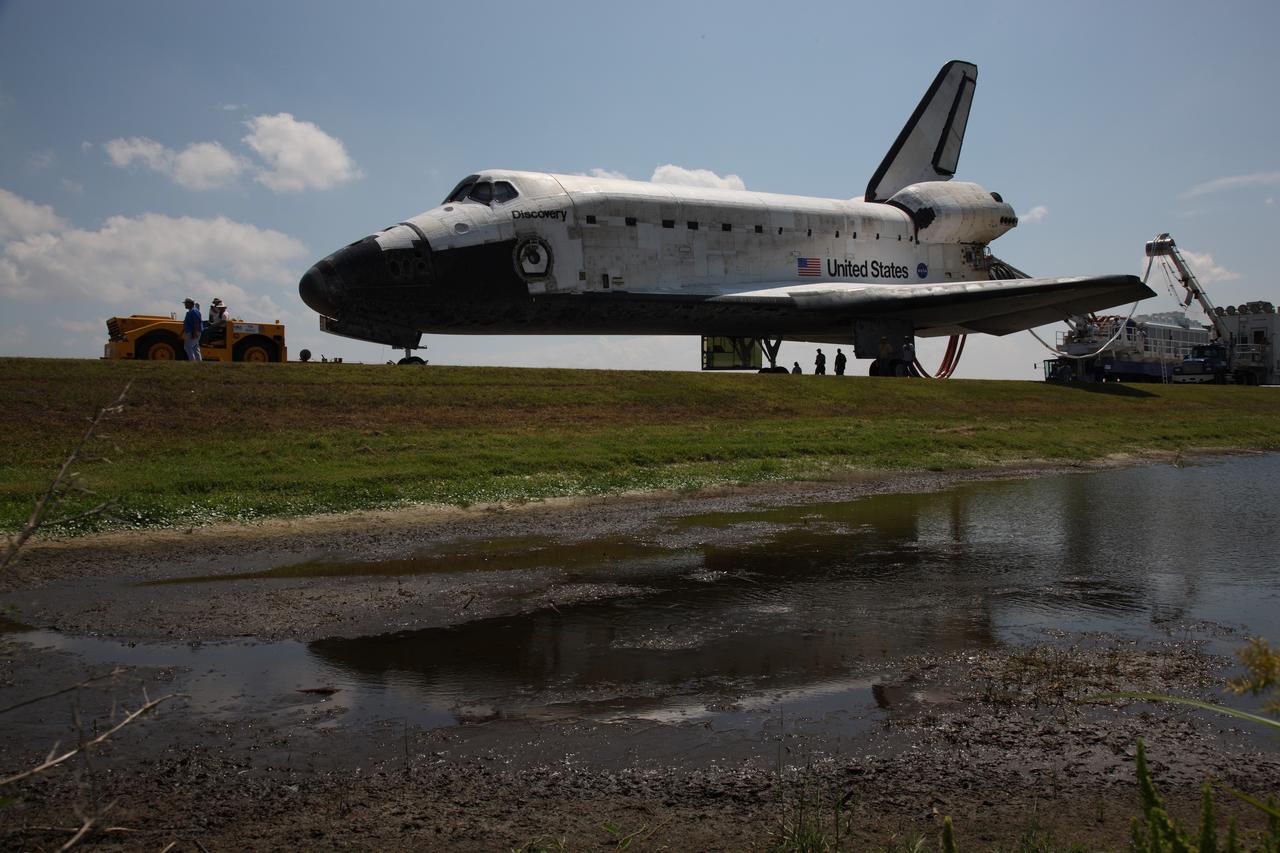 CAPE CANAVERAL, Fla. – Shadows in the water next to the runway reflect space shuttle Discovery being towed from the Shuttle Landing Facility at NASA's Kennedy Space Center. Discovery's landing ended the 14-day, STS-124 mission to the International Space Station. The STS-124 mission delivered the Japan Aerospace Exploration Agency's large Japanese Pressurized Module and its remote manipulator system to the International Space Station. The landing was on time at 11:15 a.m. EDT. Photo courtesy of Scott Andrews.