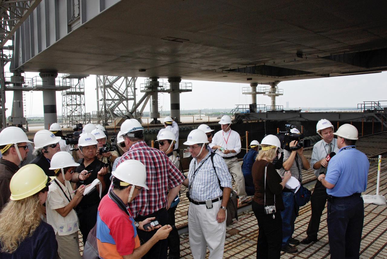CAPE CANAVERAL, Fla. – The media gather on Launch Pad 39A at NASA's Kennedy Space Center to view the flame trench damaged during the May 31 launch of space shuttle Discovery. Reporters had the opportunity to ask questions of Ed Mango, deputy director of the shuttle program's launch vehicle processing, and Perry Becker, who is leading the launch pad engineering investigation team. Repairs are expected to be completed in time for space shuttle Atlantis' STS-125 mission to NASA's Hubble Space Telescope targeted for Oct. 8. Photo credit: NASA/Kim Shiflett