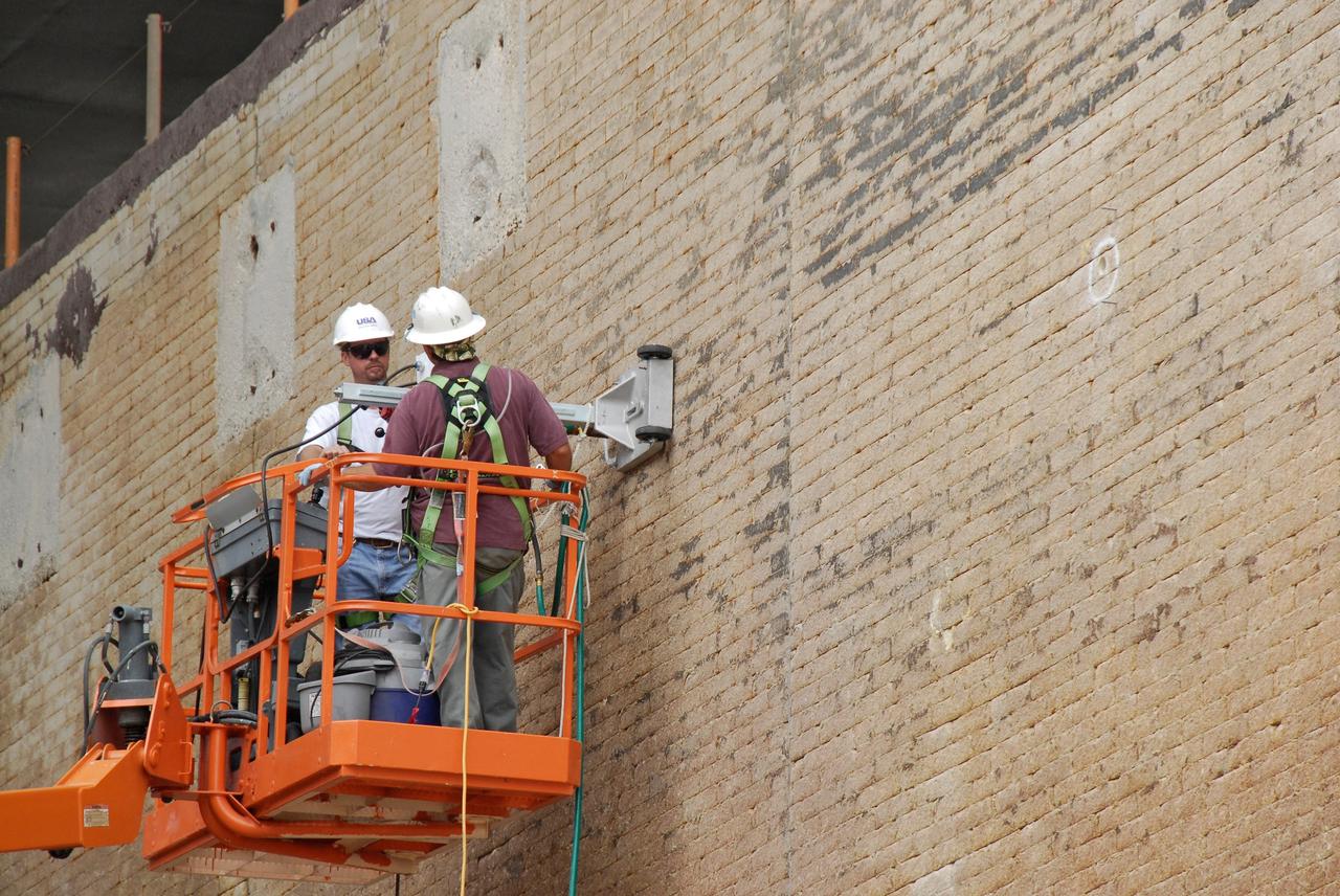 CAPE CANAVERAL, Fla. – Workers test the stability of the wall of the flame trench on Launch Pad 39A at NASA's Kennedy Space Center where damage occurred during the May 31 launch of space shuttle Discovery. Repairs are expected to be completed in time for space shuttle Atlantis' STS-125 mission to NASA's Hubble Space Telescope targeted for Oct. 8. Photo credit: NASA/Kim Shiflett