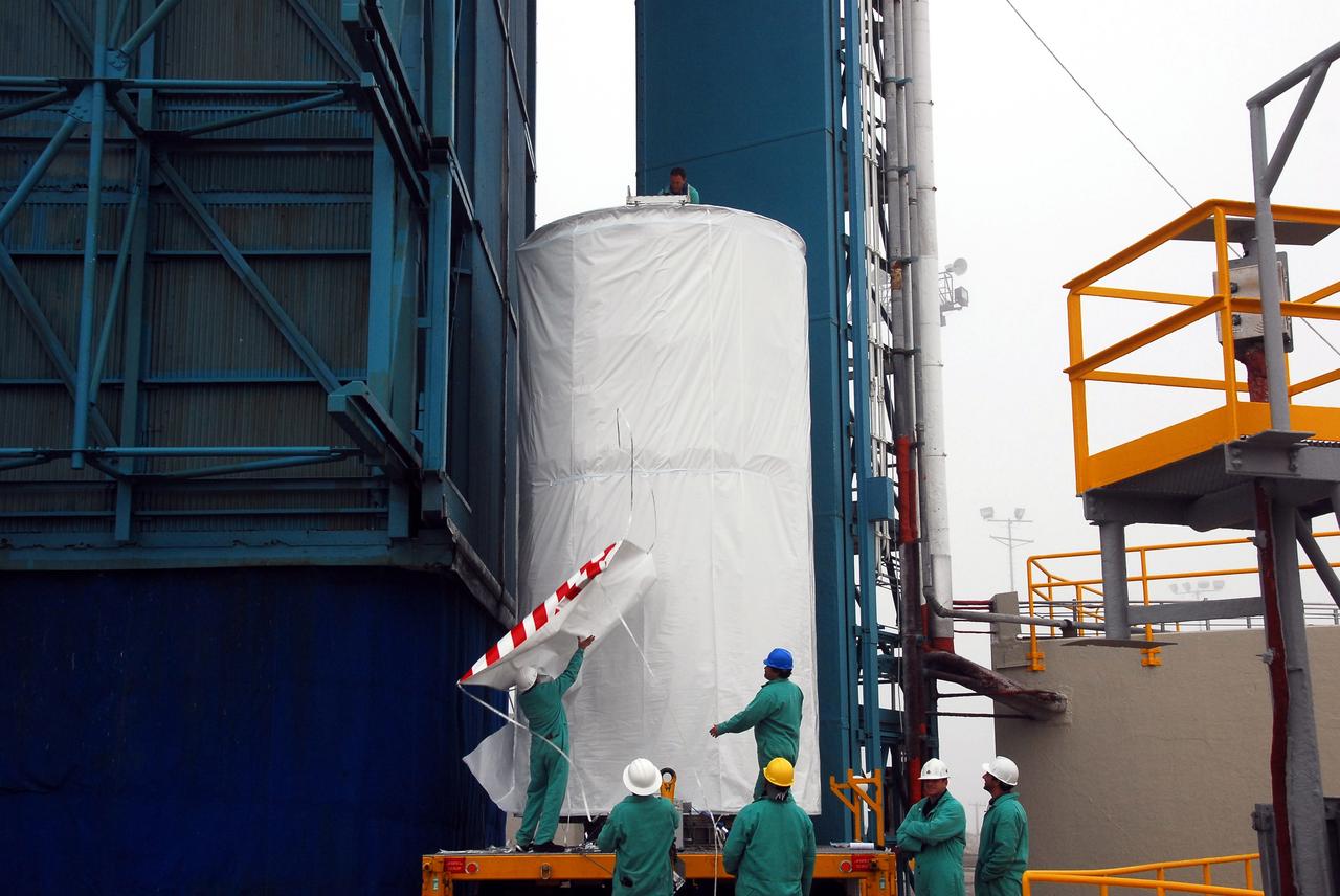 VANDENBERG AIR FORCE BASE, Calif. –  On Space Launch Complex 2, the Ocean Surface Topography Mission, or OSTM/Jason 2, spacecraft is prepared to be lifted into the mobile service tower.  In the tower it will mated with its Delta II launch vehicle. The launch window extends from 12:46 a.m. to 12:55 a.m. PDT. The satellite will be placed in an 830-mile-high orbit at an inclination of 66 degrees after separating from the Delta II 55 minutes after liftoff.  The five primary science instruments of the Ocean Surface Topography Mission aboard the Jason 2 spacecraft are dedicated to measuring the height of the ocean surface. These measurements will be used to evaluate and forecast climate changes and improve weather forecasting. The results also are expected to help forecasters better predict hurricane intensity.