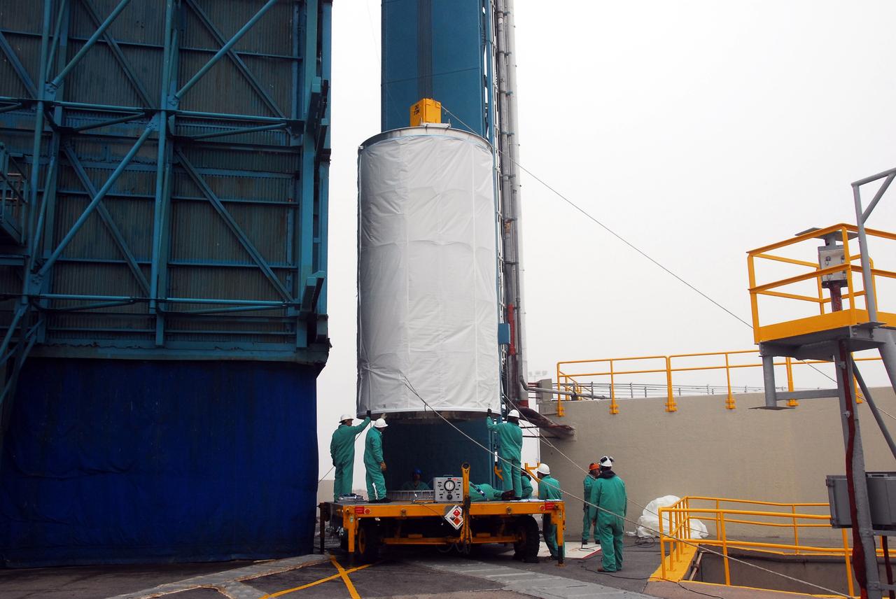 VANDENBERG AIR FORCE BASE, Calif. –  On Space Launch Complex 2, workers get ready to lift the Ocean Surface Topography Mission, or OSTM/Jason 2, spacecraft into the mobile service tower.  In the tower it will mated with its Delta II launch vehicle. The launch window extends from 12:46 a.m. to 12:55 a.m. PDT. The satellite will be placed in an 830-mile-high orbit at an inclination of 66 degrees after separating from the Delta II 55 minutes after liftoff.  The five primary science instruments of the Ocean Surface Topography Mission aboard the Jason 2 spacecraft are dedicated to measuring the height of the ocean surface. These measurements will be used to evaluate and forecast climate changes and improve weather forecasting. The results also are expected to help forecasters better predict hurricane intensity.