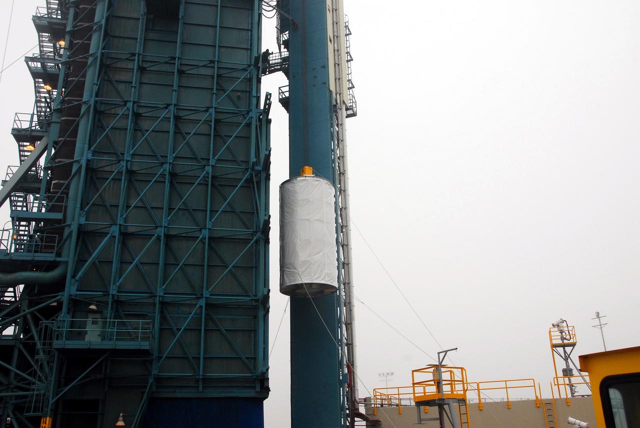VANDENBERG AIR FORCE BASE, Calif. –  On Space Launch Complex 2, the Ocean Surface Topography Mission, or OSTM/Jason 2, spacecraft is lifted alongside the mobile service tower.  In the tower it will mated with its Delta II launch vehicle. The launch window extends from 12:46 a.m. to 12:55 a.m. PDT. The satellite will be placed in an 830-mile-high orbit at an inclination of 66 degrees after separating from the Delta II 55 minutes after liftoff.  The five primary science instruments of the Ocean Surface Topography Mission aboard the Jason 2 spacecraft are dedicated to measuring the height of the ocean surface. These measurements will be used to evaluate and forecast climate changes and improve weather forecasting. The results also are expected to help forecasters better predict hurricane intensity.