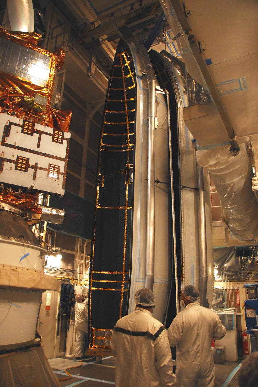 VANDENBERG AIR FORCE BASE, Calif. –   In the mobile service tower on Space Launch Complex 2, the first half of the fairing (at right) is being moved toward the Ocean Surface Topography Mission, or OSTM/Jason 2, spacecraft for encapsulation. The fairing is a molded structure that fits flush with the outside surface of the Delta II upper stage booster and forms an aerodynamically smooth nose cone, protecting the spacecraft during launch and ascent. The launch of the OSTM/Jason-2 is scheduled for June 20 from Vandenberg Air Force Base. The launch window extends from 12:46 a.m. to 12:55 a.m. PDT. The satellite will be placed in an 830-mile-high orbit at an inclination of 66 degrees after separating from the Delta II 55 minutes after liftoff.  The five primary science instruments of the Ocean Surface Topography Mission aboard the Jason 2 spacecraft are dedicated to measuring the height of the ocean surface. These measurements will be used to evaluate and forecast climate changes and improve weather forecasting. The results also are expected to help forecasters better predict hurricane intensity.