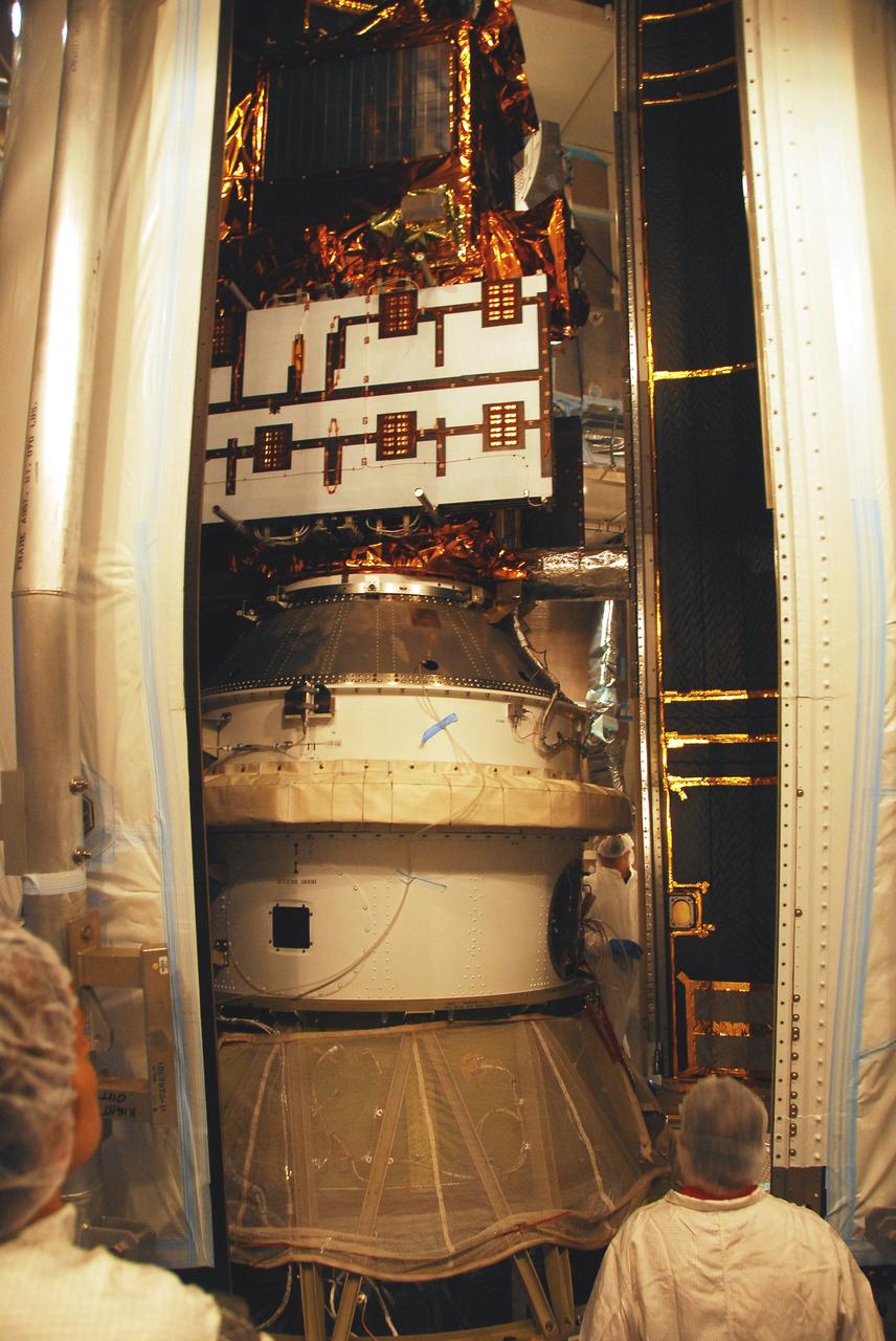 VANDENBERG AIR FORCE BASE, Calif. –   In the mobile service tower on Space Launch Complex 2, the second half of the fairing moves close to the Ocean Surface Topography Mission, or OSTM/Jason 2, spacecraft to complete encapsulation. The fairing is a molded structure that fits flush with the outside surface of the Delta II upper stage booster and forms an aerodynamically smooth nose cone, protecting the spacecraft during launch and ascent. The launch of the OSTM/Jason-2 is scheduled for June 20 from Vandenberg Air Force Base. The launch window extends from 12:46 a.m. to 12:55 a.m. PDT. The satellite will be placed in an 830-mile-high orbit at an inclination of 66 degrees after separating from the Delta II 55 minutes after liftoff.  The five primary science instruments of the Ocean Surface Topography Mission aboard the Jason 2 spacecraft are dedicated to measuring the height of the ocean surface. These measurements will be used to evaluate and forecast climate changes and improve weather forecasting. The results also are expected to help forecasters better predict hurricane intensity.