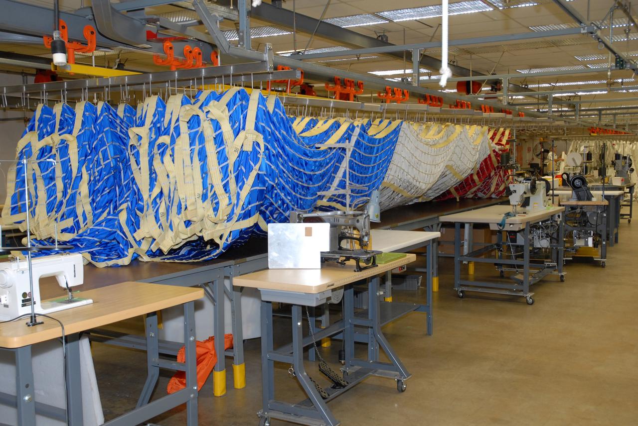 CAPE CANAVERAL, Fla. – In the Parachute Refurbishment Facility at NASA's Kennedy Space Center, parachutes for the Ares rockets are being prepared for packing. Ares I is an in-line, two-stage rocket that will transport the Orion crew exploration vehicle to low-Earth orbit. The Ares I first stage will be a five-segment solid rocket booster based on the four-segment design used for the shuttle. As with the shuttle, this booster will fall away when spent, lowered by parachute into the Atlantic Ocean where it can be retrieved for re-use. Unlike the shuttle, the booster will be flying faster, at Mach 6, when its separation from the rest of Ares I occurs. Photo credit: NASA/Jack Pfaller