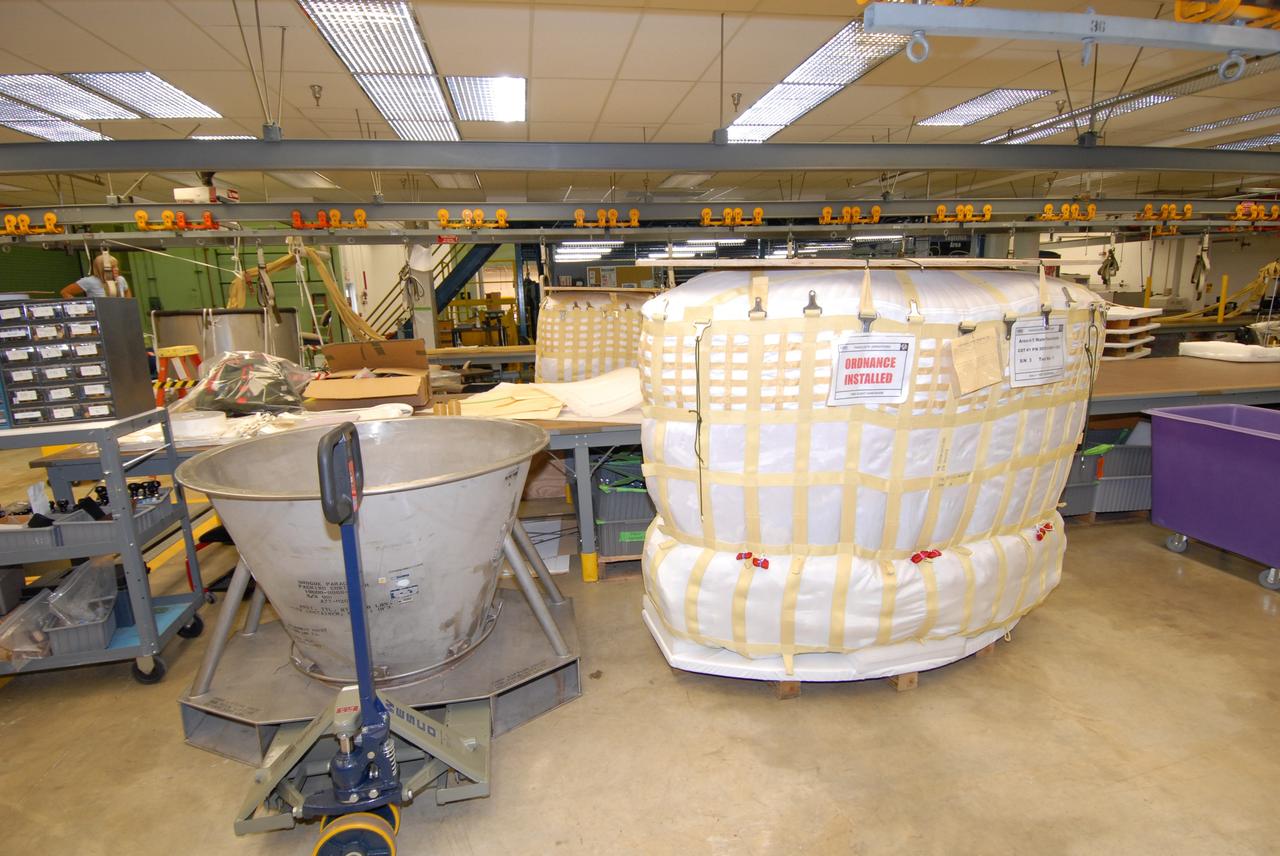 CAPE CANAVERAL, Fla. – In the Parachute Refurbishment Facility at NASA's Kennedy Space Center, parachutes for the Ares rockets are being prepared for packing. Ares I is an in-line, two-stage rocket that will transport the Orion crew exploration vehicle to low-Earth orbit. The Ares I first stage will be a five-segment solid rocket booster based on the four-segment design used for the shuttle. As with the shuttle, this booster will fall away when spent, lowered by parachute into the Atlantic Ocean where it can be retrieved for re-use. Unlike the shuttle, the booster will be flying faster, at Mach 6, when its separation from the rest of Ares I occurs. Photo credit: NASA/Jack Pfaller