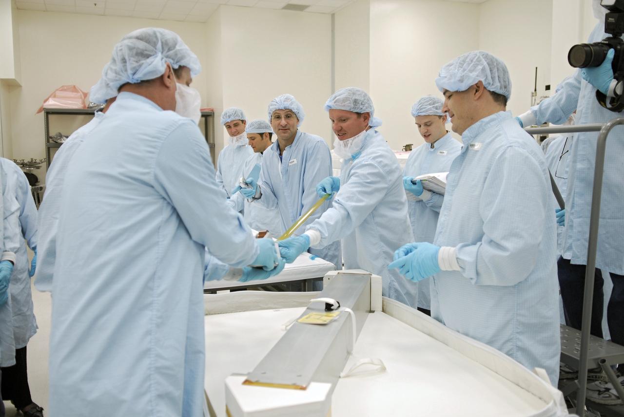 CAPE CANAVERAL, Fla.  –  In the Space Station Processing Facility at NASA's Kennedy Space Center, STS-126 crew members handle equipment that will fly on the mission.  At center is Mission Specialist Donald Pettit; on the right is Pilot Eric Boe.  Shuttle crews frequently visit Kennedy  to get hands-on experience, called a crew equipment interface test,  with hardware and equipment for their missions.  On STS-126, Endeavour will deliver a multi-purpose logistics module to the International Space Station. Launch is targeted for Nov. 10.   Photo credit: NASA/Kim Shiflett