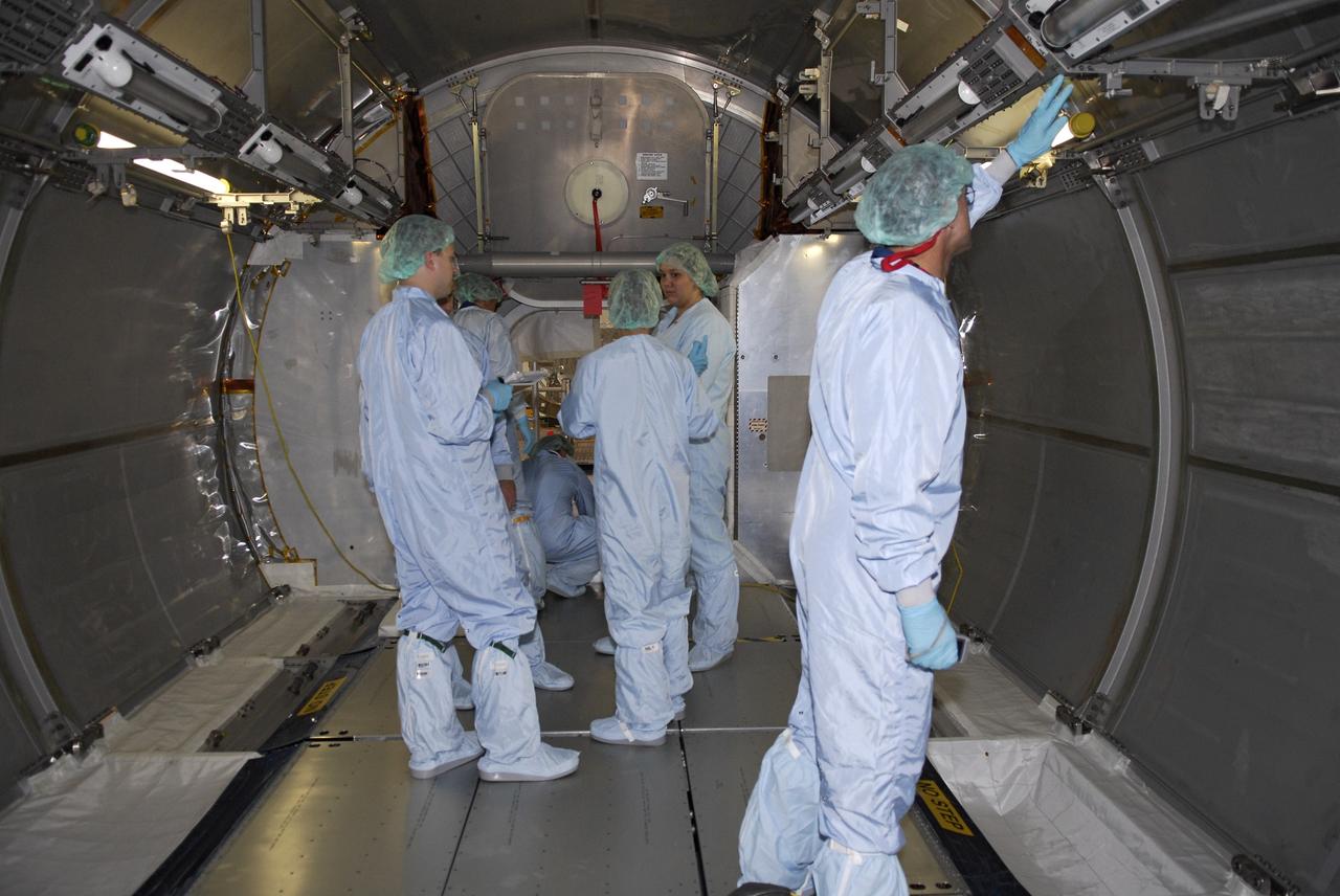 CAPE CANAVERAL, Fla.  –  In the Space Station Processing Facility at NASA's Kennedy Space Center, STS-126 crew members check out the interior of the multi-purpose logistics module that will fly on the mission.   Shuttle crews frequently visit Kennedy  to get hands-on experience, called a crew equipment interface test, with hardware and equipment for their missions.  On STS-126, Endeavour will deliver a multi-purpose logistics module to the International Space Station. Launch is targeted for Nov. 10.   Photo credit: NASA/Kim Shiflett