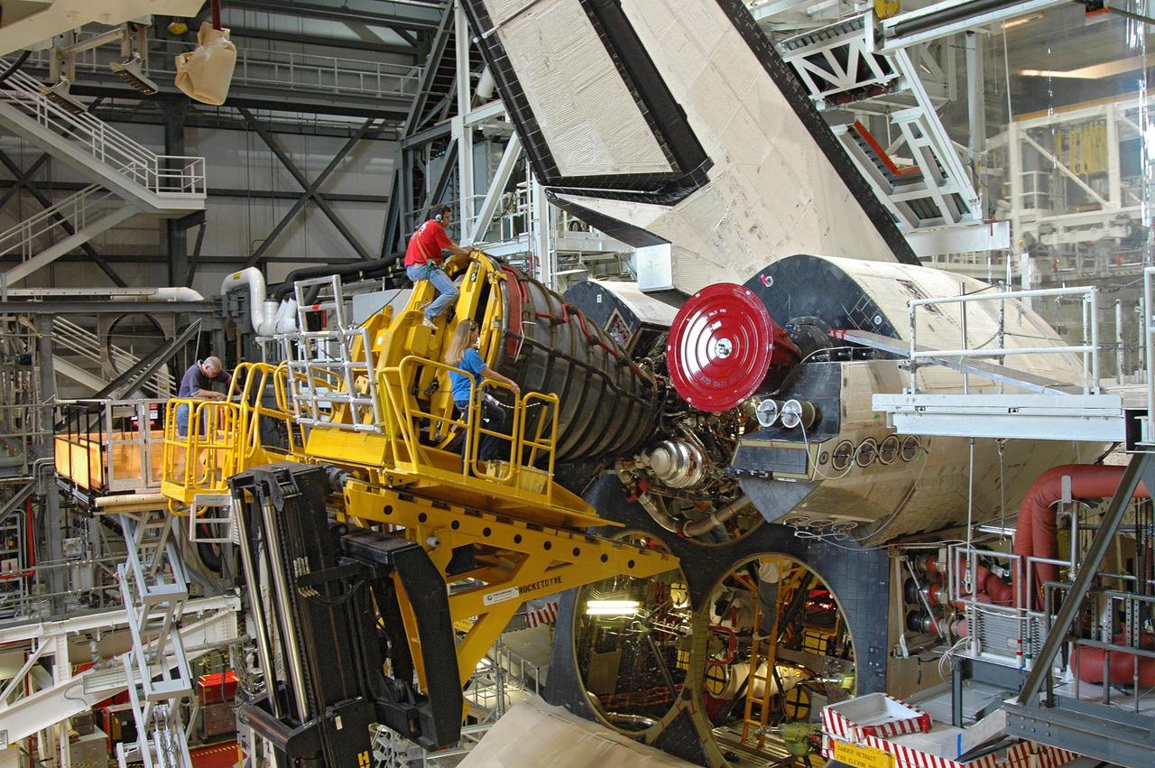CAPE CANAVERAL, Fla. – In the Orbiter Processing Facility bay 2, technicians work the engine installer to maneuver main engine 1 into place on space shuttle Endeavour. The scheduled launch vehicle for the STS-126 mission, Endeavour will deliver a multi-purpose logistics module to the International Space Station. Launch is targeted for Nov. 10. Endeavour is also the backup shuttle, if needed for rescue, for the STS-125 mission in October that will make repairs on the Hubble Space Telescope. For that purpose, it is designated STS-400. Photo credit: NASA/Jim Grossmann