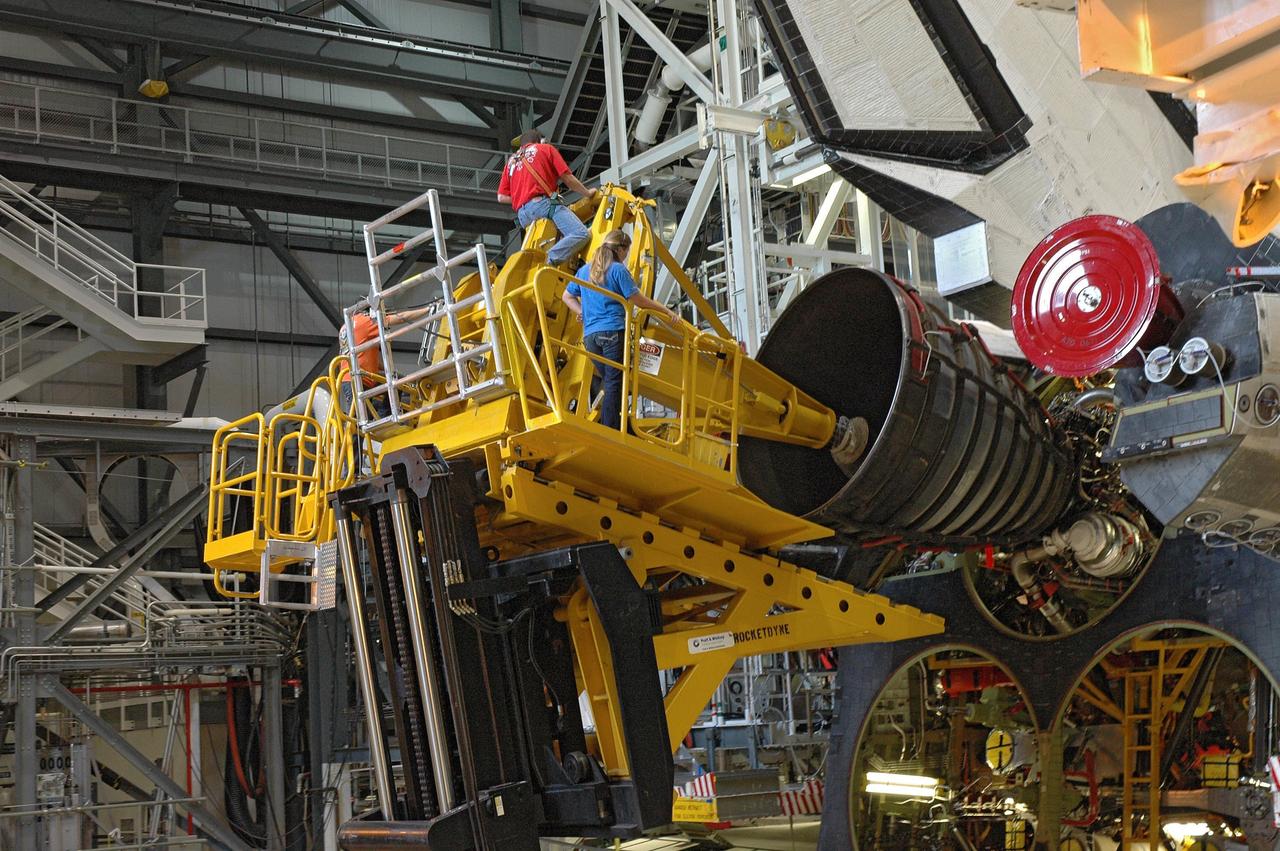 CAPE CANAVERAL, Fla. – In the Orbiter Processing Facility bay 2, technicians work the engine installer to maneuver main engine 1 into place on space shuttle Endeavour. The scheduled launch vehicle for the STS-126 mission, Endeavour will deliver a multi-purpose logistics module to the International Space Station. Launch is targeted for Nov. 10. Endeavour is also the backup shuttle, if needed for rescue, for the STS-125 mission in October that will make repairs on the Hubble Space Telescope. For that purpose, it is designated STS-400. Photo credit: NASA/Jim Grossmann