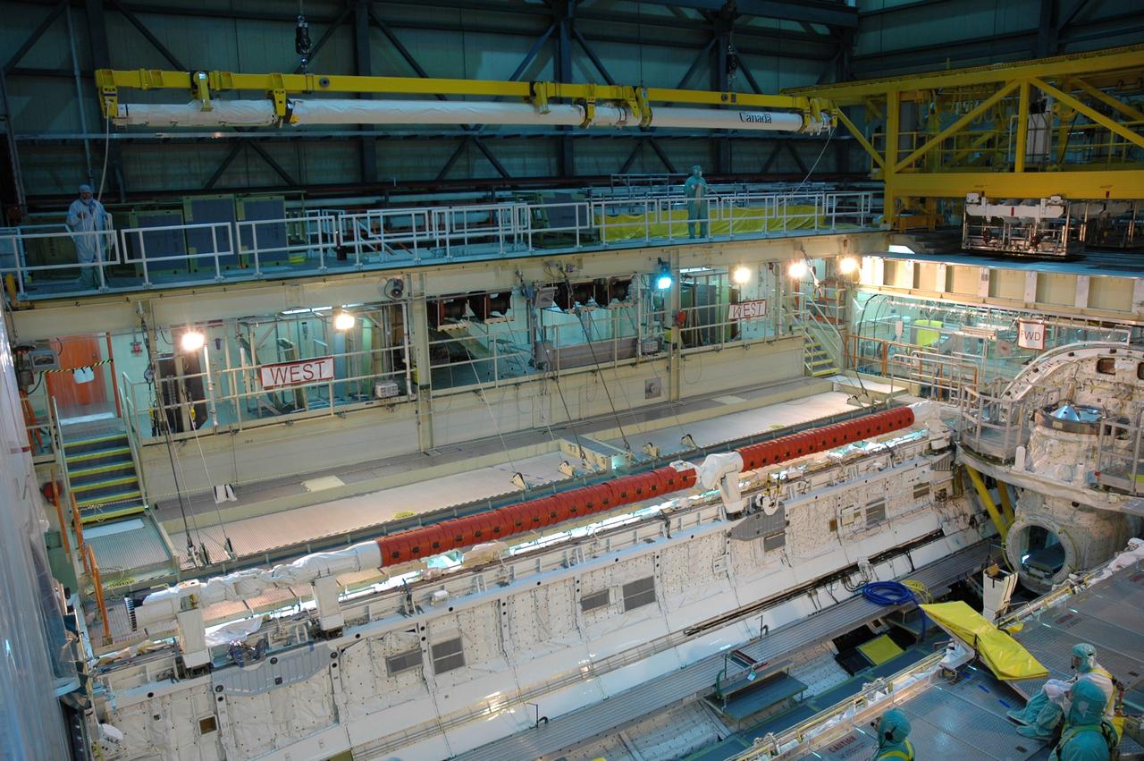 CAPE CANAVERAL, Fla. – In the Orbiter Processing Facility bay 3, space shuttle Discovery's robotic arm (top of photo) is being moved for installation in the shuttle's payload bay. Scheduled to launch on the STS-119 mission, Discovery will carry the S6 truss segment to complete the 361-foot-long backbone of the International Space Station. The truss includes the fourth pair of solar array wings and electronics that convert sunlight to power for the orbiting laboratory. A launch date has not yet been determined. Photo credit: NASA/Jim Grossmann