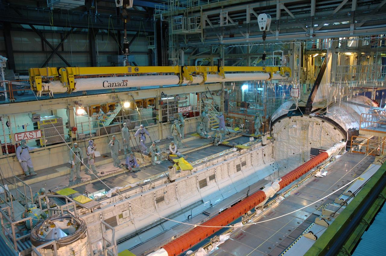 CAPE CANAVERAL, Fla. – In the Orbiter Processing Facility bay 3, space shuttle Discovery's robotic arm (top of photo) is being moved for installation in the shuttle's payload bay. Scheduled to launch on the STS-119 mission, Discovery will carry the S6 truss segment to complete the 361-foot-long backbone of the International Space Station. The truss includes the fourth pair of solar array wings and electronics that convert sunlight to power for the orbiting laboratory. A launch date has not yet been determined. Photo credit: NASA/Jim Grossmann