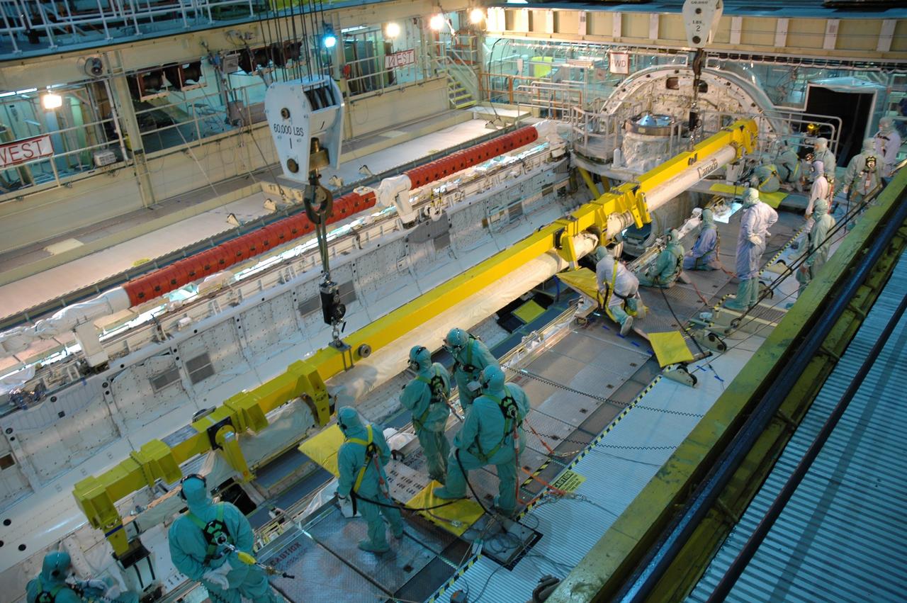 CAPE CANAVERAL, Fla. – In the Orbiter Processing Facility bay 3, space shuttle Discovery's robotic arm is moved into place for installation in the payload bay. Scheduled to launch on the STS-119 mission, Discovery will carry the S6 truss segment to complete the 361-foot-long backbone of the International Space Station. The truss includes the fourth pair of solar array wings and electronics that convert sunlight to power for the orbiting laboratory. A launch date has not yet been determined. Photo credit: NASA/Jim Grossmann