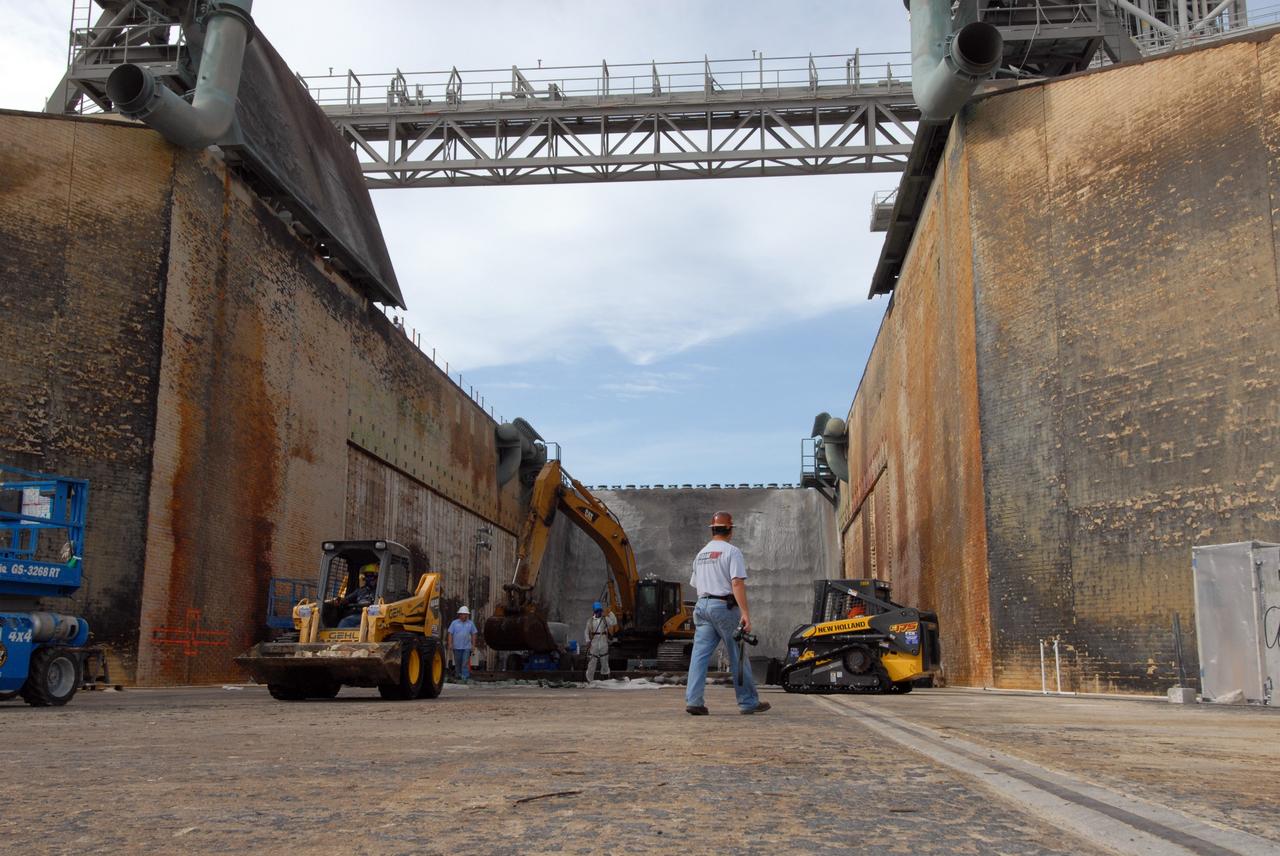 CAPE CANAVERAL, Fla. – Repairs are ongoing in the flame trench on Launch Pad 39A at NASA's Kennedy Space Center. Damage to the trench occurred during the launch of Discovery on the STS-124 mission. A 75- by 20-foot section of the east wall was destroyed and debris scattered as far as the pad perimeter fence. Repairs are expected to be completed before the targeted Oct. 8 launch of Atlantis on the STS-125 mission. Photo credit: NASA/Jack Pfaller