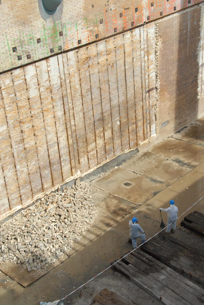 CAPE CANAVERAL, Fla. – A close-up of repair work under way on the flame trench on Launch Pad 39A at NASA's Kennedy Space Center. Damage to the trench occurred during the launch of Discovery on the STS-124 mission. A 75- by 20-foot section of the east wall was destroyed and debris scattered as far as the pad perimeter fence. Repairs are expected to be completed before the targeted Oct. 8 launch of Atlantis on the STS-125 mission. Photo credit: NASA/Jack Pfaller