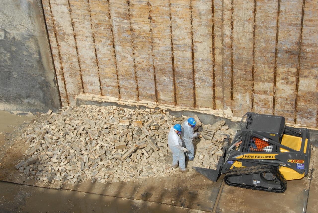 CAPE CANAVERAL, Fla. – A close-up of repair work under way on the flame trench on Launch Pad 39A at NASA's Kennedy Space Center. Damage to the trench occurred during the launch of Discovery on the STS-124 mission. A 75- by 20-foot section of the east wall was destroyed and debris scattered as far as the pad perimeter fence. Repairs are expected to be completed before the targeted Oct. 8 launch of Atlantis on the STS-125 mission. Photo credit: NASA/Jack Pfaller