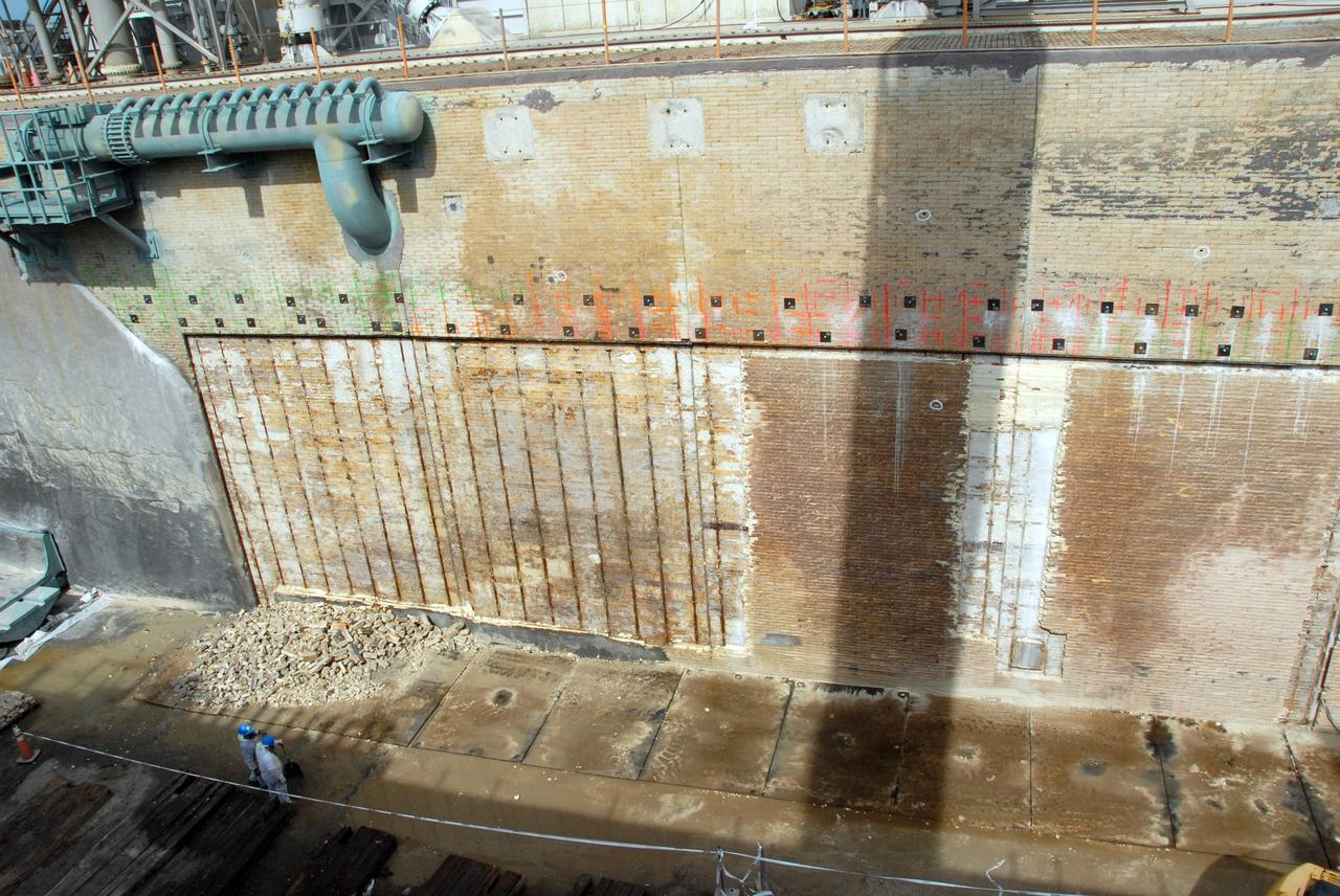 CAPE CANAVERAL, Fla. – A close-up of repair work under way on the flame trench on Launch Pad 39A at NASA's Kennedy Space Center. Damage to the trench occurred during the launch of Discovery on the STS-124 mission. A 75- by 20-foot section of the east wall was destroyed and debris scattered as far as the pad perimeter fence. Repairs are expected to be completed before the targeted Oct. 8 launch of Atlantis on the STS-125 mission. Photo credit: NASA/Jack Pfaller