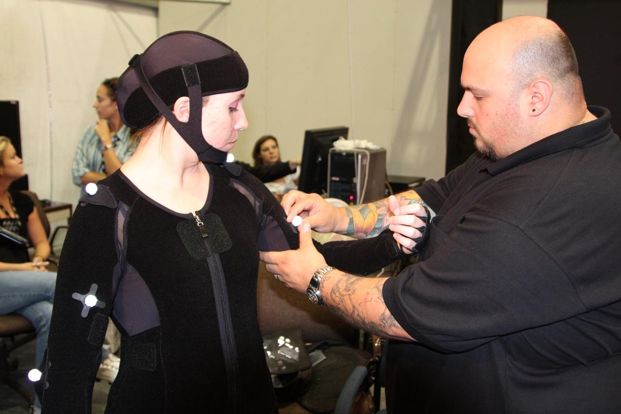 CAPE CANAVERAL, Fla. – NYIT MOCAP (Motion Capture) team Project Manager Jon Squitieri attaches a retro reflective marker to a motion capture suit worn by a technician who will be assembling the Orion Crew Module mockup. The motion tracking aims to improve efficiency of assembly processes and identify potential ergonomic risks for technicians assembling the mockup. The work is being performed in United Space Alliance's Human Engineering Modeling and Performance Lab in the RLV Hangar at NASA's Kennedy Space Center. Part of NASA's Constellation Program, the Orion spacecraft will return humans to the moon and prepare for future voyages to Mars and other destinations in our solar system.