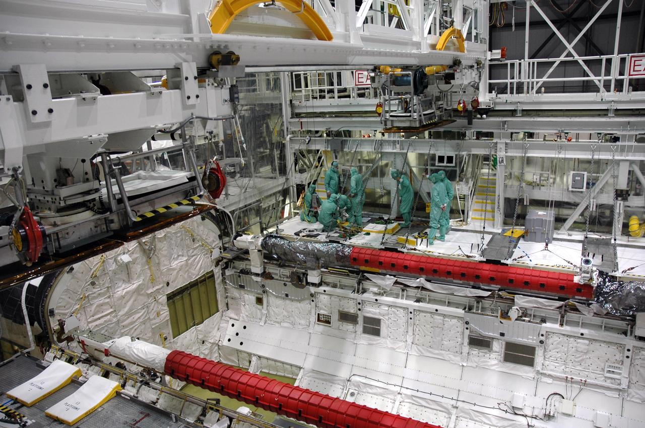 CAPE CANAVERAL, Fla. – In the Orbiter Processing Facility bay 2 at NASA's Kennedy Space Center, workers prepare to install a camera pack on the orbiter boom sensor system in space shuttle Endeavour's payload bay. The scheduled launch vehicle for the STS-126 missions, Endeavour will deliver a multi-purpose logistics module to the International Space Station. Launch is targeted for Nov. 10. Endeavour is also the backup shuttle, if needed for rescue, for the STS-125 mission in October that will make repairs on NASA's Hubble Space Telescope. For that purpose, it is designated STS-400. Photo credit: NASA/Jim Grossmann
