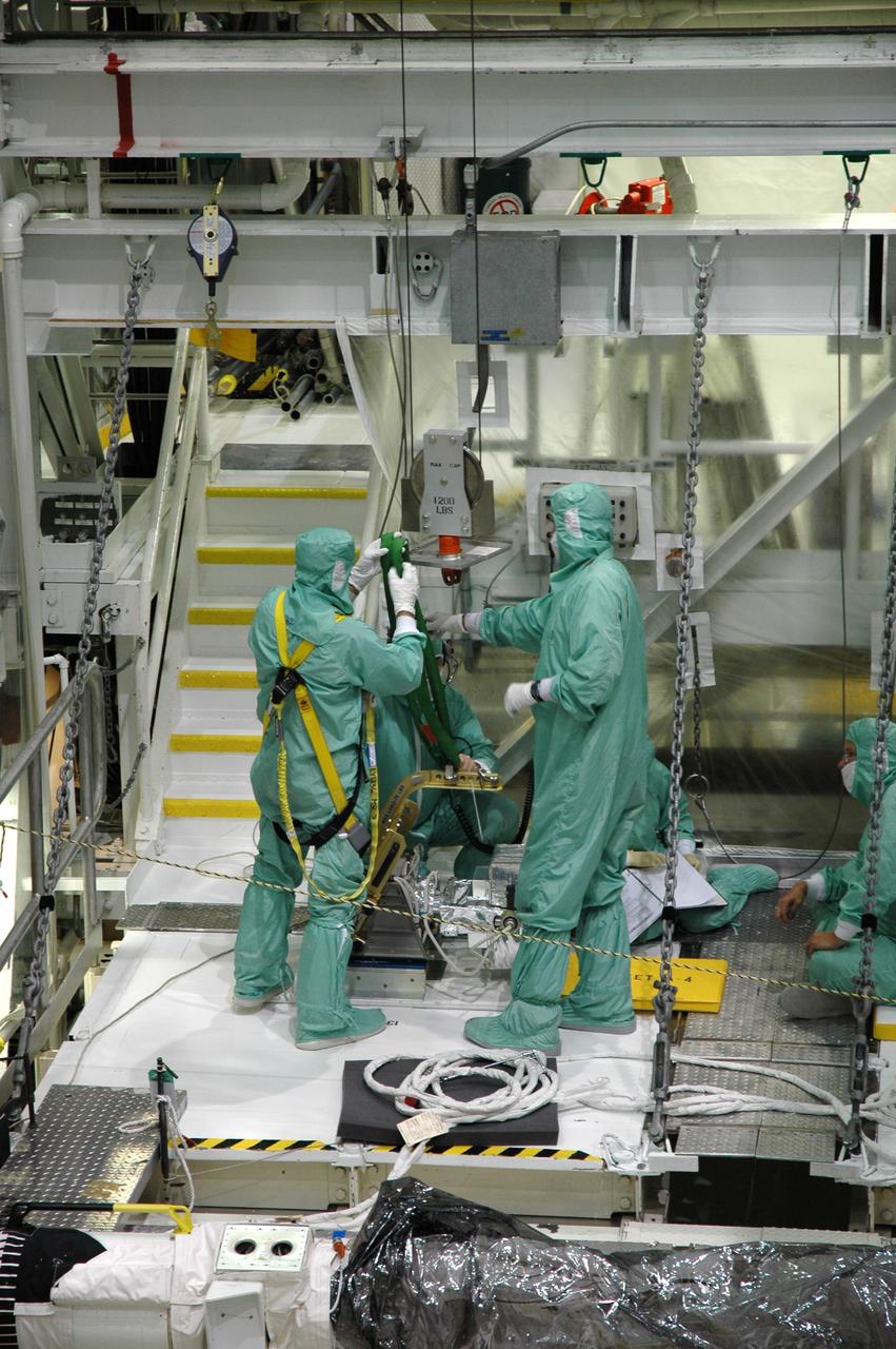 CAPE CANAVERAL, Fla. – In the Orbiter Processing Facility bay 2 at NASA's Kennedy Space Center, workers prepare to install a camera pack on the orbiter boom sensor system in space shuttle Endeavour's payload bay. The scheduled launch vehicle for the STS-126 missions, Endeavour will deliver a multi-purpose logistics module to the International Space Station. Launch is targeted for Nov. 10. Endeavour is also the backup shuttle, if needed for rescue, for the STS-125 mission in October that will make repairs on NASA's Hubble Space Telescope. For that purpose, it is designated STS-400. Photo credit: NASA/Jim Grossmann