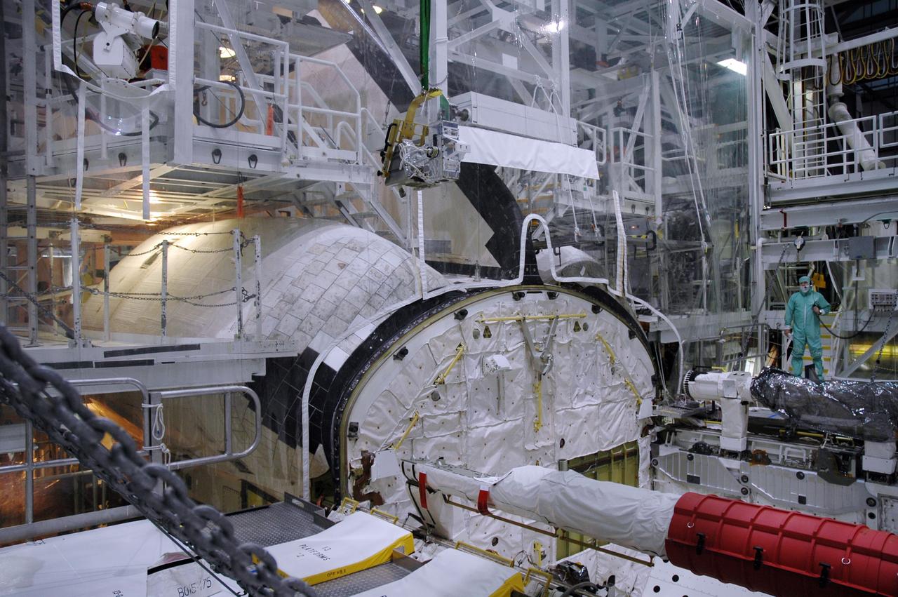 CAPE CANAVERAL, Fla. – In the Orbiter Processing Facility bay 2 at NASA's Kennedy Space Center, a camera pack is moved above space shuttle Endeavour's payload bay. The camera will be installed on the shuttle's orbiter boom sensor system. The scheduled launch vehicle for the STS-126 missions, Endeavour will deliver a multi-purpose logistics module to the International Space Station. Launch is targeted for Nov. 10. Endeavour is also the backup shuttle, if needed for rescue, for the STS-125 mission in October that will make repairs on NASA's Hubble Space Telescope. For that purpose, it is designated STS-400. Photo credit: NASA/Jim Grossmann