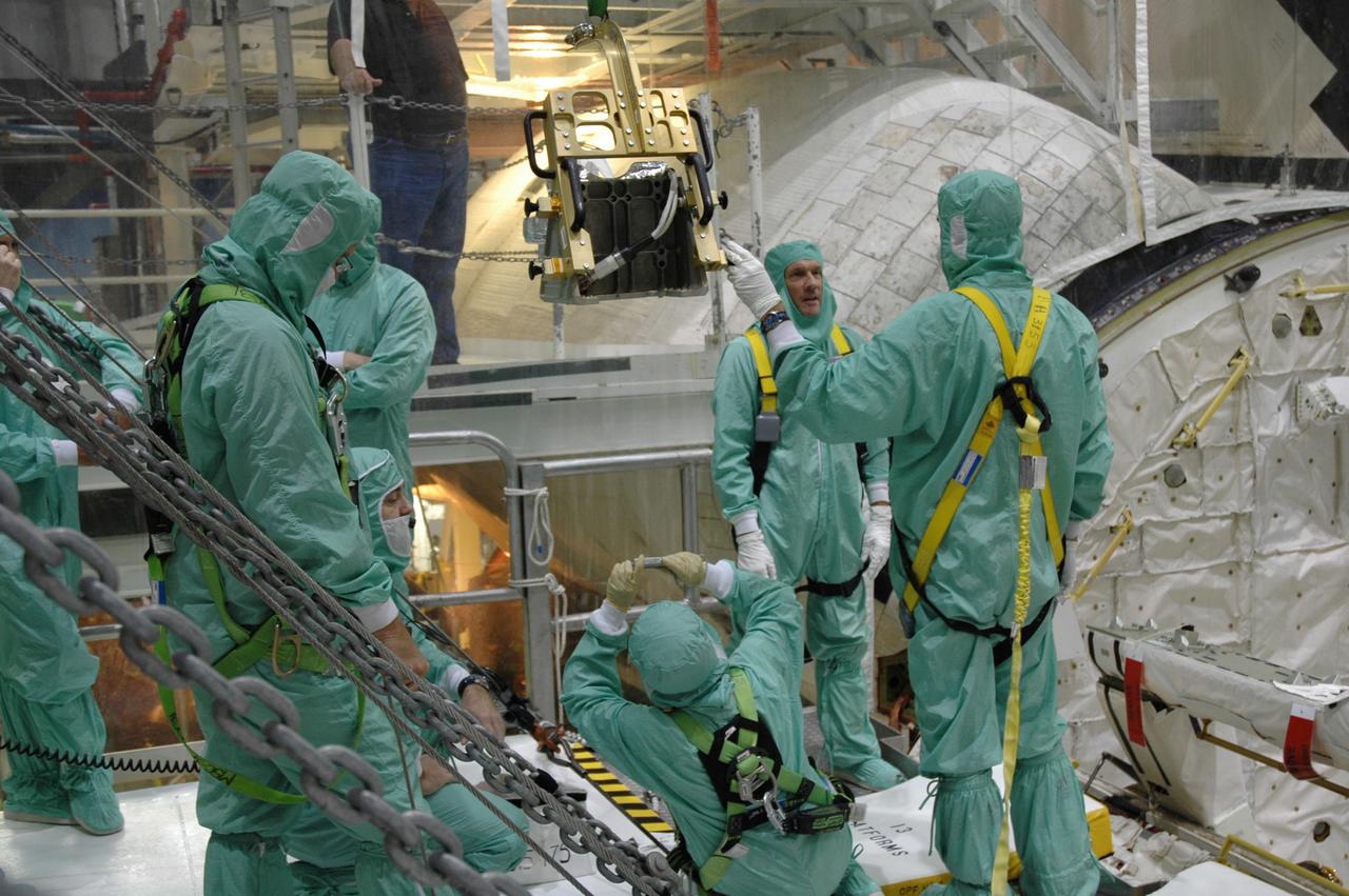 CAPE CANAVERAL, Fla. – In the Orbiter Processing Facility bay 2 at NASA's Kennedy Space Center, workers get ready to install a camera pack on the orbiter boom sensor system in space shuttle Endeavour's payload bay. The scheduled launch vehicle for the STS-126 missions, Endeavour will deliver a multi-purpose logistics module to the International Space Station. Launch is targeted for Nov. 10. Endeavour is also the backup shuttle, if needed for rescue, for the STS-125 mission in October that will make repairs on NASA's Hubble Space Telescope. For that purpose, it is designated STS-400. Photo credit: NASA/Jim Grossmann