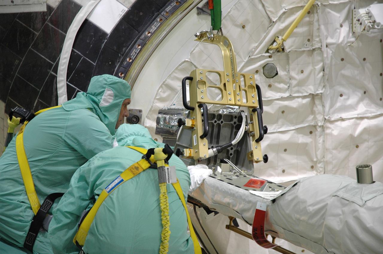 CAPE CANAVERAL, Fla. – In the Orbiter Processing Facility bay 2 at NASA's Kennedy Space Center, workers install a camera pack on the orbiter boom sensor system in space shuttle Endeavour's payload bay. The scheduled launch vehicle for the STS-126 missions, Endeavour will deliver a multi-purpose logistics module to the International Space Station. Launch is targeted for Nov. 10. Endeavour is also the backup shuttle, if needed for rescue, for the STS-125 mission in October that will make repairs on NASA's Hubble Space Telescope. For that purpose, it is designated STS-400. Photo credit: NASA/Jim Grossmann