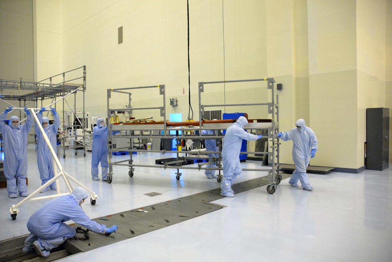 CAPE CANAVERAL, Fla. – In the Payload Hazardous Servicing Facility at NASA's Kennedy Space Center, workers move a piece of flight support system (FSS) access scaffolding. The scaffolding will be used to prepare the Hubble Space Telescope, or HST, carriers for the STS-125 servicing mission 4. The FSS will berth, secure and furnish power to Hubble and also contains the soft capture mechanism to be attached to the telescope. Upon completion of STS-125, the Hubble will provide even deeper and more detailed views of the Universe. The STS-125 mission will be the final space shuttle mission to the Hubble Space Telescope. Photo credit: NASA/Jack Pfaller
