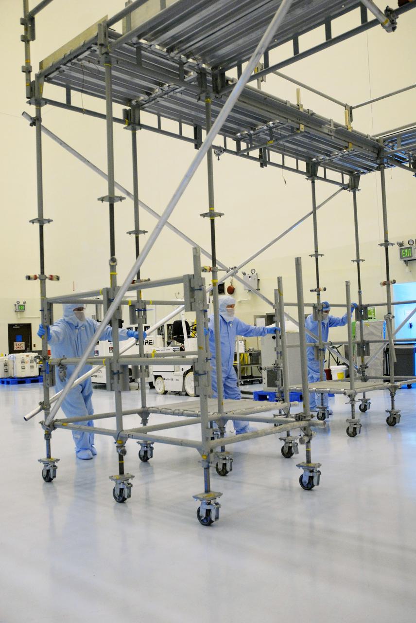 CAPE CANAVERAL, Fla. – In the Payload Hazardous Servicing Facility at NASA's Kennedy Space Center, workers move flight support system (FSS) access scaffolding that will be used to prepare the Hubble Space Telescope, or HST, carriers for the STS-125 servicing mission 4. The FSS will berth, secure and furnish power to Hubble and also contains the soft capture mechanism to be attached to the telescope. Upon completion of STS-125, the Hubble will provide even deeper and more detailed views of the Universe. The STS-125 mission will be the final space shuttle mission to the Hubble Space Telescope. Photo credit: NASA/Jack Pfaller