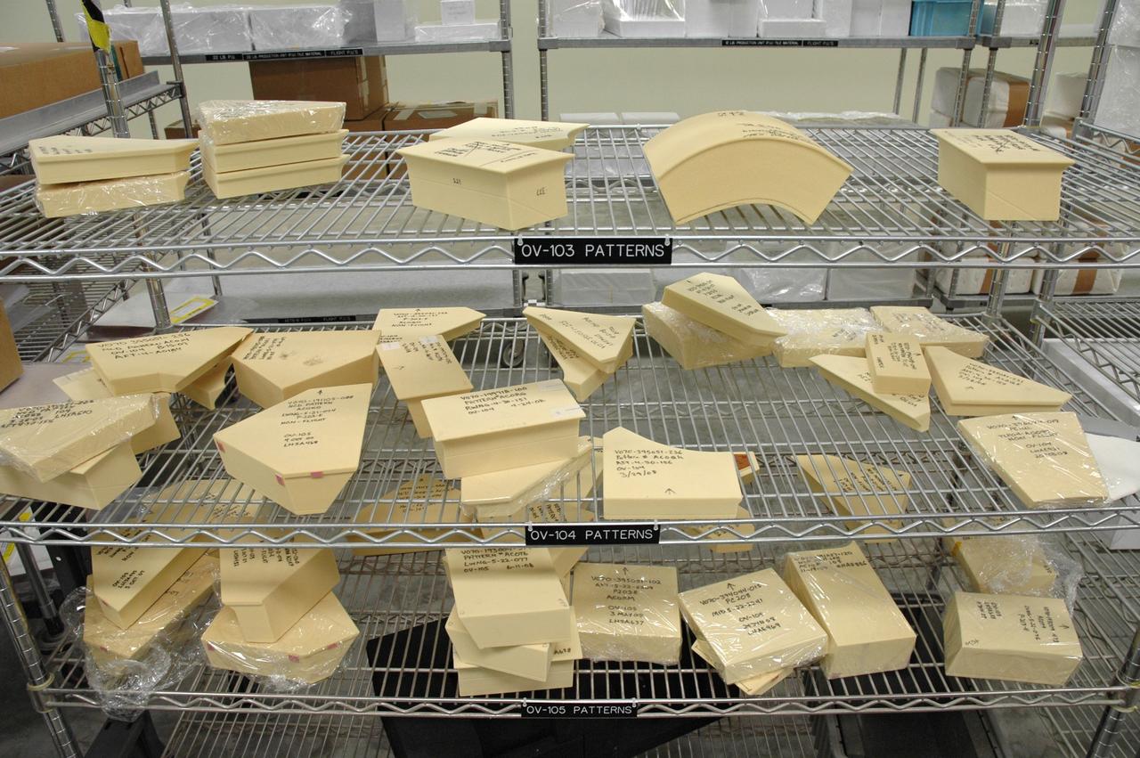 CAPE CANAVERAL, Fla. –  In the Tile Shop at NASA's Kennedy Space Center, Boeing Rigid Insulation-18, or BRI-18, tiles of different shapes await use on the three orbiters: Discovery, Atlantis and Endeavour.  BRI-18 is the strongest material used for thermal insulation on the orbiters and, when coated to produce toughened unipiece fibrous insulation, provides a tile with extremely high-impact resistance.  It is replacing tiles on areas of the vehicle where impact risk is high.  These areas include the landing gear doors, the wing leading edge and the external tank doors.  Photo credit: NASA/Jim Grossmann