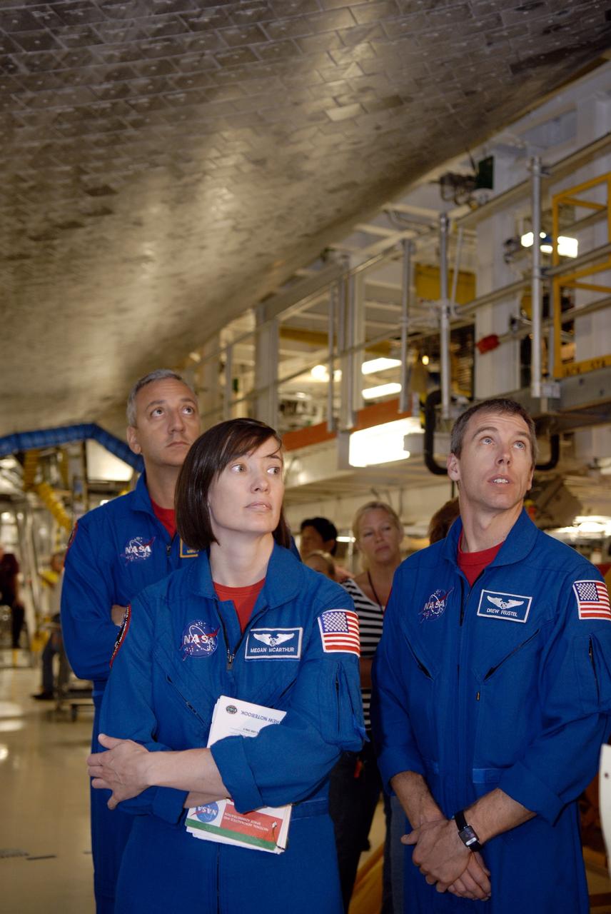 CAPE CANAVERAL, Fla. –  In the Orbiter Processing Facility at NASA's Kennedy Space Center, STS-125 Mission Specialists Mike Massimino, Megan McArthur and Andrew Feustel stand underneath space shuttle Atlantis during the crew equipment interface test. The CEIT provides hands-on experience with hardware and equipment for their mission.  Atlantis is targeted to launch on the STS-125 Hubble Servicing Mission 4 on Oct. 8.  Photo credit: NASA/Kim Shiflett