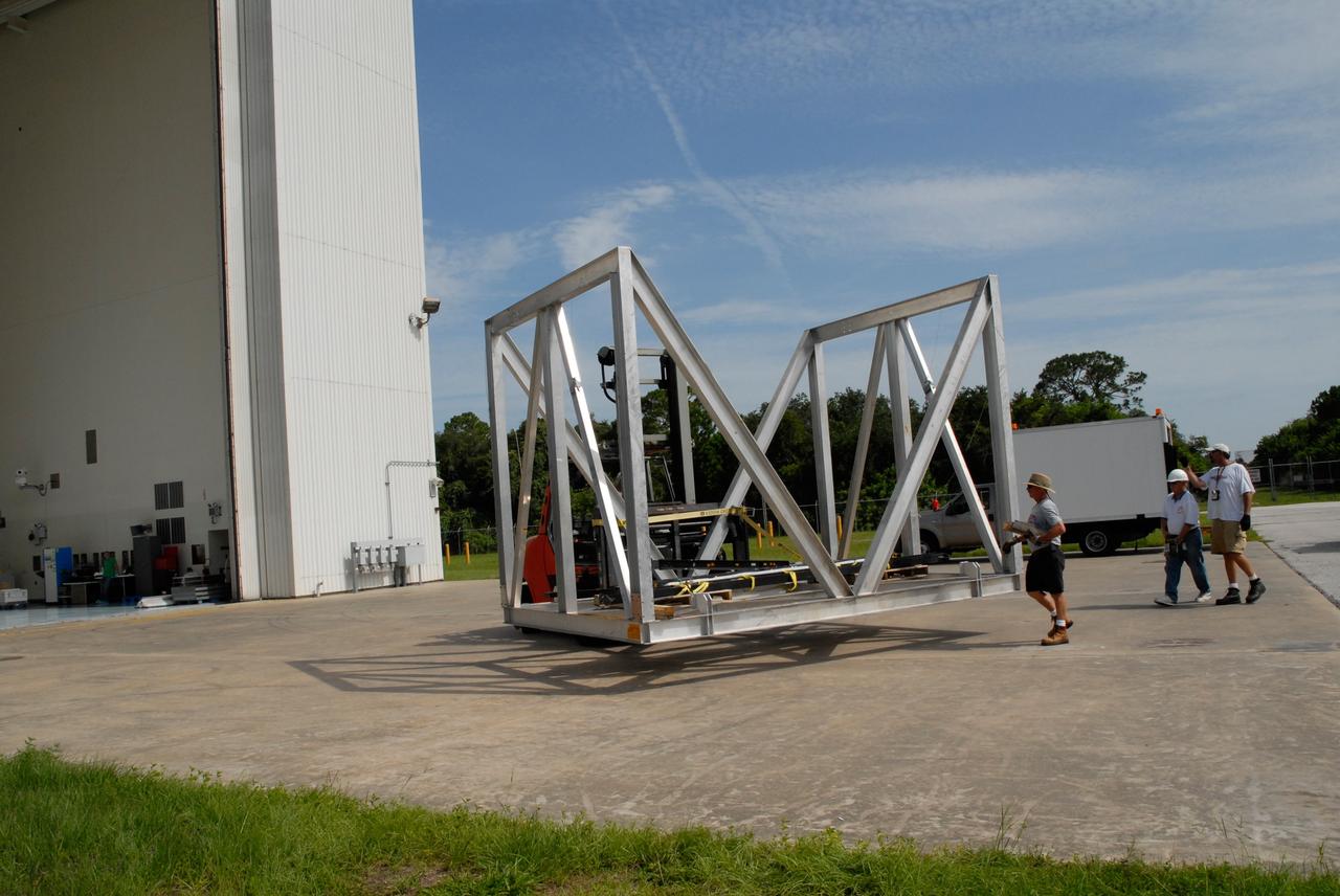 CAPE CANAVERAL, Fla. – The thermal vacuum fixture is transferred to a transporter in front of the Payload Hazardous Servicing Center at NASA's Kennedy Space Center. The fixture will be used to hold the carrier and flight support system for the STS-125 Hubble Space Telescope Servicing Mission 4. Space shuttle Atlantis is targeted to launch on the STS-125 mission Oct. 8. The mission crew will perform history-making, on-orbit “surgery” on two important science instruments aboard the telescope. After capturing the telescope, two teams of spacewalking astronauts will perform the repairs during five planned spacewalks. Photo credit: NASA/Jack Pfaller