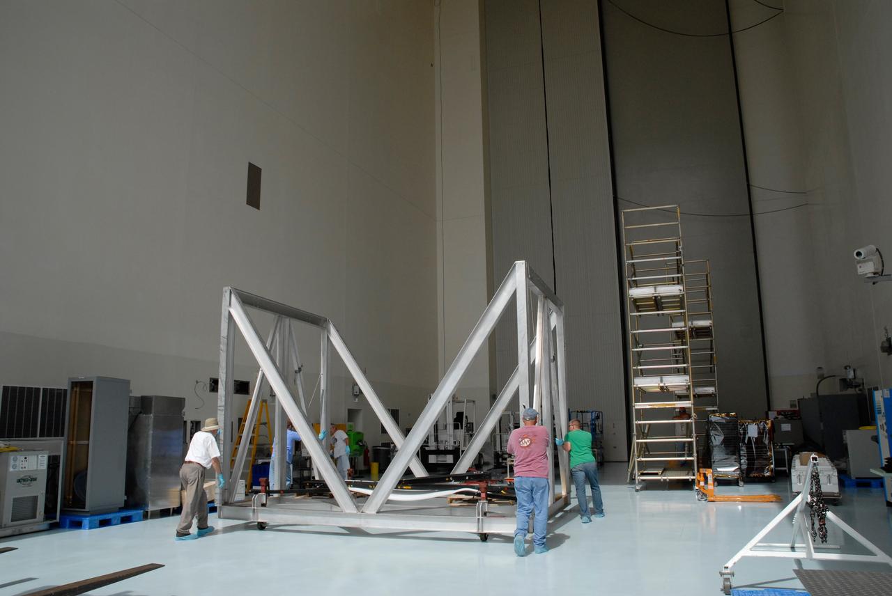 CAPE CANAVERAL, Fla. – At NASA's Kennedy Space Center, workers move the thermal vacuum fixture deeper into the Payload Hazardous Servicing Center. Space shuttle Atlantis is targeted to launch on the STS-125 mission Oct. 8. The mission crew will perform history-making, on-orbit “surgery” on two important science instruments aboard the telescope. After capturing the telescope, two teams of spacewalking astronauts will perform the repairs during five planned spacewalks. Photo credit: NASA/Jack Pfaller