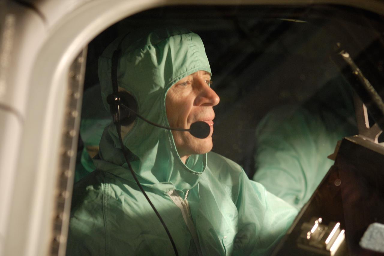 CAPE CANAVERAL, Fla. – In the Orbiter Processing Facility at NASA's Kennedy Space Center, STS-125 Pilot Gregory C. Johnson examines the cockpit window on space shuttle Atlantis, checking for sharp edges. The inspection is part of the crew equipment interface test, which provides hands-on experience with hardware and equipment for the mission. Atlantis is targeted to launch Oct. 8 on the STS-125 mission to service the Hubble Space Telescope. The mission crew will perform history-making, on-orbit “surgery” on two important science instruments aboard the telescope. After capturing the telescope, two teams of spacewalking astronauts will perform the repairs during five planned spacewalks. Photo credit: NASA/Kim Shiflett