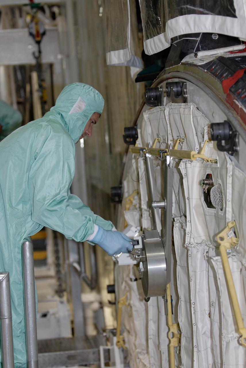 CAPE CANAVERAL, Fla. –  In the Orbiter Processing Facility at NASA's Kennedy Space Center, STS-125 Mission Specialist Michael Good checks out part of the equipment in space shuttle Atlantis' payload bay.  Equipment familiarization is part of the crew equipment interface test, which provides hands-on experience with hardware and equipment for the mission.  Atlantis is targeted to launch Oct. 8 on the STS-125 mission to service the Hubble Space Telescope. The mission crew will perform history-making, on-orbit “surgery” on two important science instruments aboard the telescope.  After capturing the telescope, two teams of spacewalking astronauts will perform the repairs during five planned spacewalks.    Photo credit: NASA/Kim Shiflett