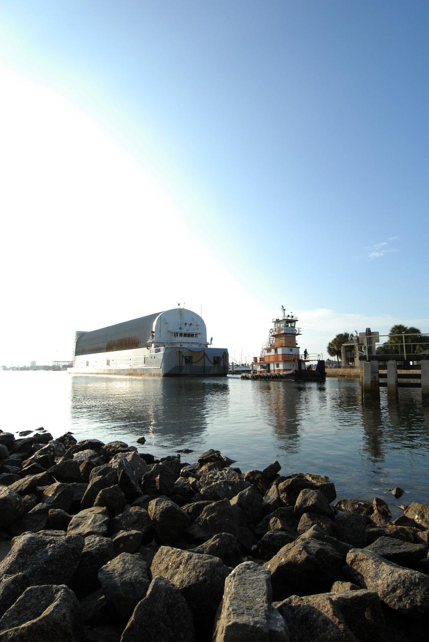 CAPE CANAVERAL, Fla. – The external fuel tank for space shuttle Atlantis' STS-125 mission to NASA's Hubble Space Telescope is towed to the turn basin in the Launch Complex 39 Area at NASA's Kennedy Space Center, where it will be offloaded and moved to the Vehicle Assembly Building. Once inside the building, the tank will be raised to vertical, lifted and moved into a checkout cell. Stacking of the tank and solid rocket boosters is planned to start Aug. 7. Atlantis is targeted to launch Oct. 8. Photo credit: NASA/Jack Pfaller