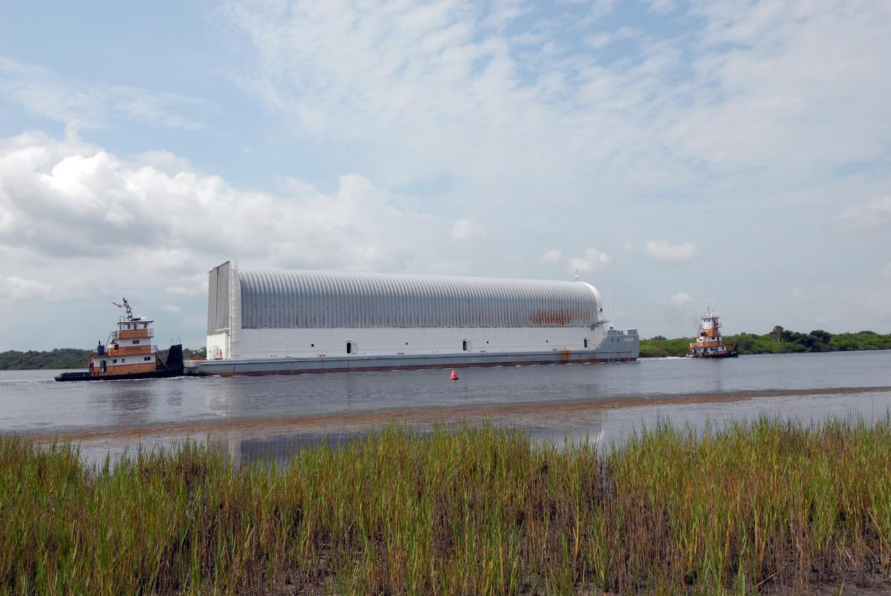 CAPE CANAVERAL, Fla. – The external fuel tank for space shuttle Atlantis' STS-125 mission to NASA's Hubble Space Telescope is towed to the turn basin in the Launch Complex 39 Area at NASA's Kennedy Space Center, where it will be offloaded and moved to the Vehicle Assembly Building. Once inside the building, the tank will be raised to vertical, lifted and moved into a checkout cell. Stacking of the tank and solid rocket boosters is planned to start Aug. 7. Atlantis is targeted to launch Oct. 8. Photo credit: NASA/Jack Pfaller