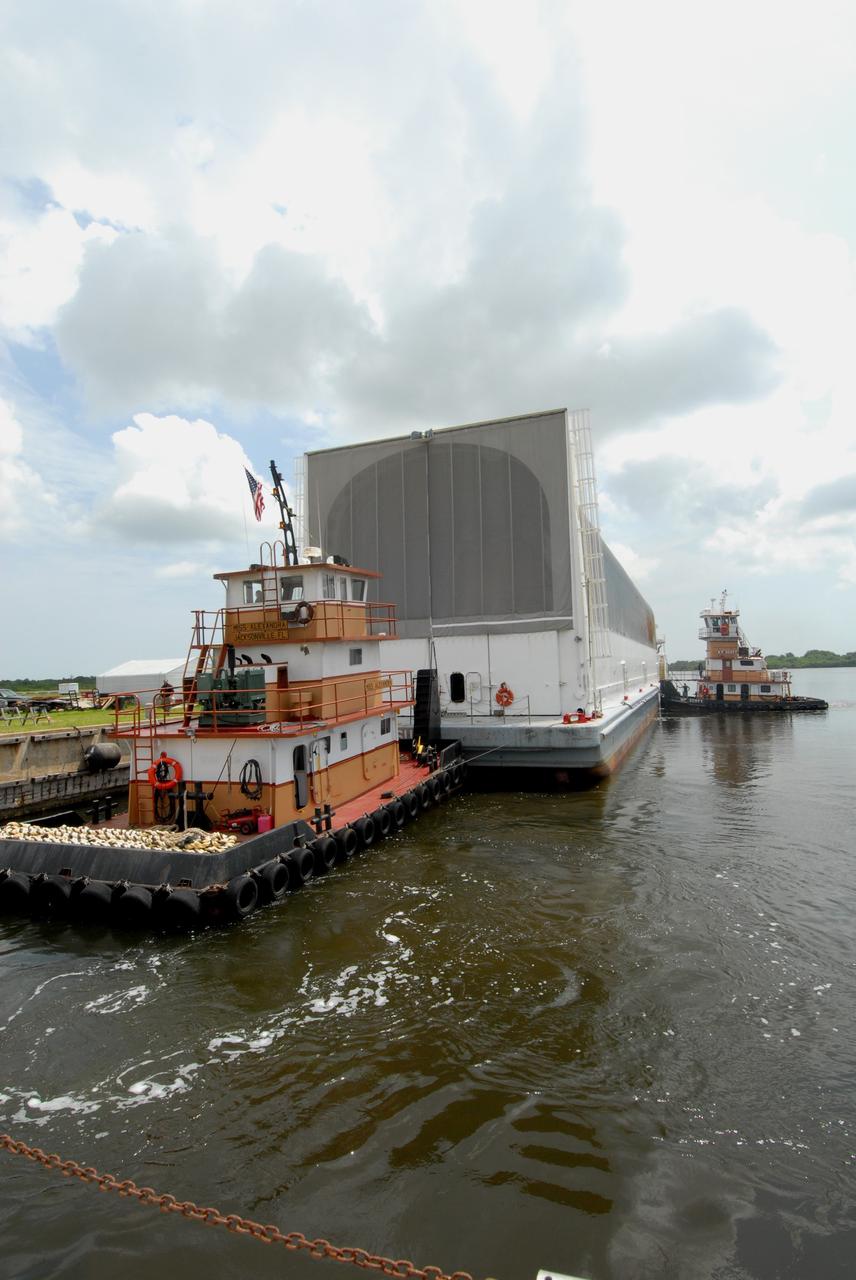 CAPE CANAVERAL, Fla. – Tugboats maneuver the Pegasus barge toward the dock in the turn basin in the Launch Complex 39 Area in NASA's Kennedy Space Center. Onboard the barge is the external fuel tank for space shuttle Atlantis' STS-125 mission to NASA's Hubble Space Telescope. After docking, the tank will be offloaded and moved to the Vehicle Assembly Building. Once inside the building, the tank will be raised to vertical, lifted and moved into a checkout cell. Stacking of the tank and solid rocket boosters is planned to start Aug. 7. Atlantis is targeted to launch Oct. 8. Photo credit: NASA/Jack Pfaller