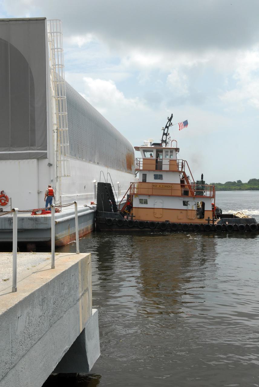 CAPE CANAVERAL, Fla. – Tugboats maneuver the Pegasus barge toward the dock in the turn basin in the Launch Complex 39 Area in NASA's Kennedy Space Center. Onboard the barge is the external fuel tank for space shuttle Atlantis' STS-125 mission to NASA's Hubble Space Telescope. After docking, the tank will be offloaded and moved to the Vehicle Assembly Building. Once inside the building, the tank will be raised to vertical, lifted and moved into a checkout cell. Stacking of the tank and solid rocket boosters is planned to start Aug. 7. Atlantis is targeted to launch Oct. 8. Photo credit: NASA/Jack Pfaller