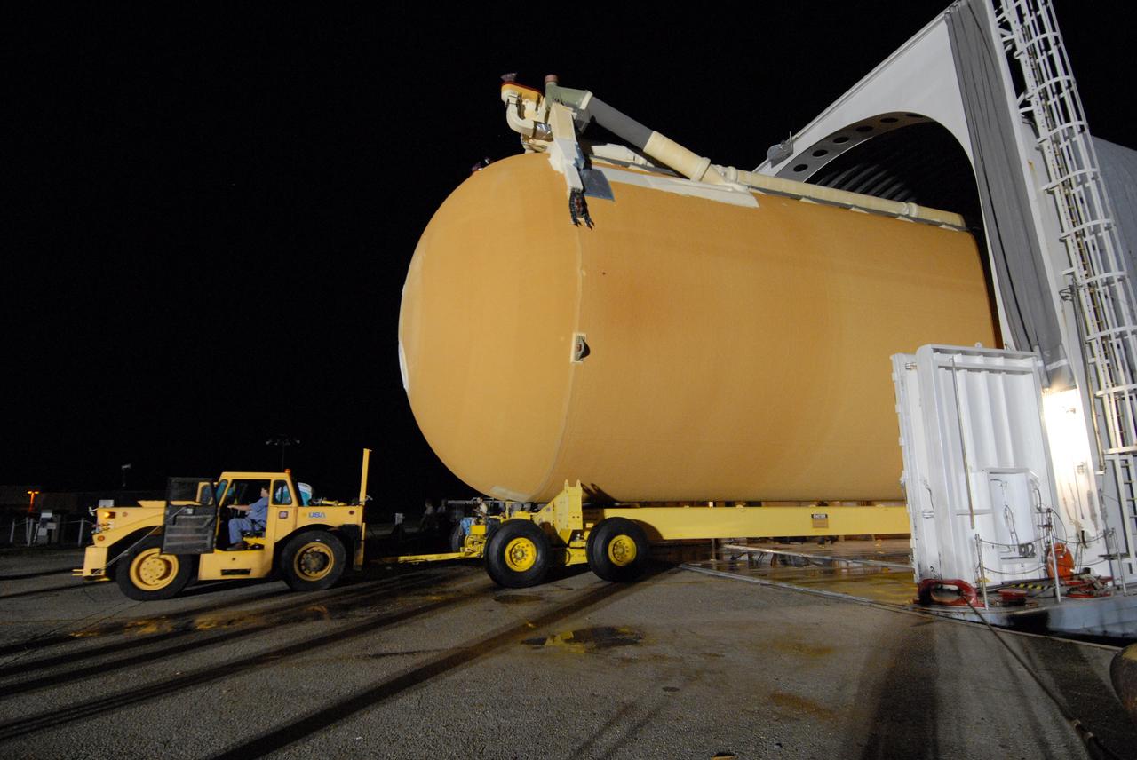 CAPE CANAVERAL, Fla. –   In the Launch Complex 39 Area at NASA's Kennedy Space Center, a transporter offloads the external tank for space shuttle Atlantis' STS-125 mission to NASA's Hubble Space Telescope off the Pegasus barge.  The tank, which arrived earlier in the day, will be moved to the Vehicle Assembly Building.    Inside the building, the tank will be raised to vertical, lifted and moved into a checkout cell.  Stacking of the tank and solid rocket boosters is scheduled for Aug. 7.  Atlantis is targeted to launch Oct. 8.  Photo credit: NASA/Amanda Diller