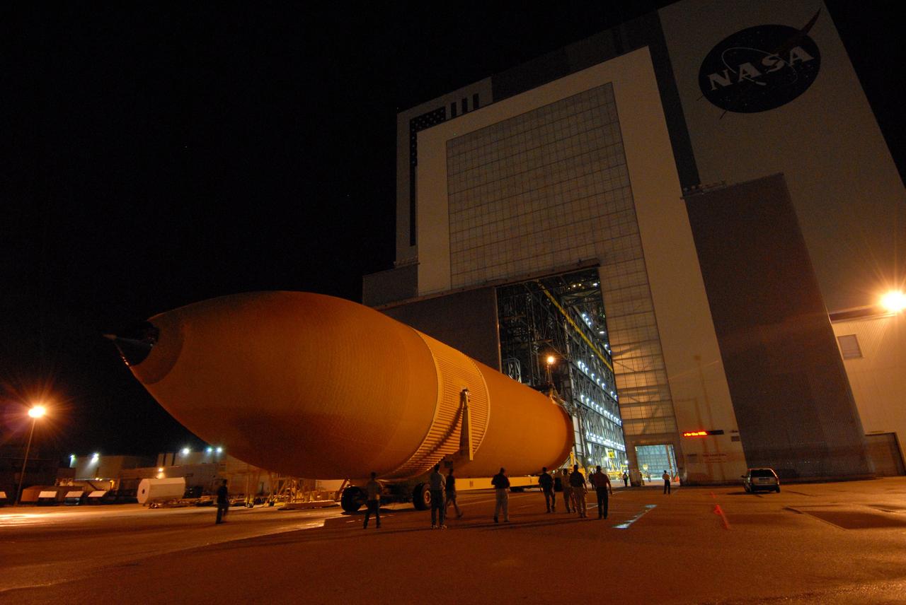 CAPE CANAVERAL, Fla. –  The external tank for space shuttle Atlantis' STS-125 mission to NASA's Hubble Space Telescope moves toward the open door of the Vehicle Assembly Building at NASA's Kennedy Space Center.  The tank arrived at the turn basin earlier in the day aboard the Pegasus barge.  Inside the building, the tank will be raised to vertical, lifted and moved into a checkout cell.  Stacking of the tank and solid rocket boosters is scheduled for Aug. 7.  Atlantis is targeted to launch Oct. 8.  Photo credit: NASA/Amanda Diller
