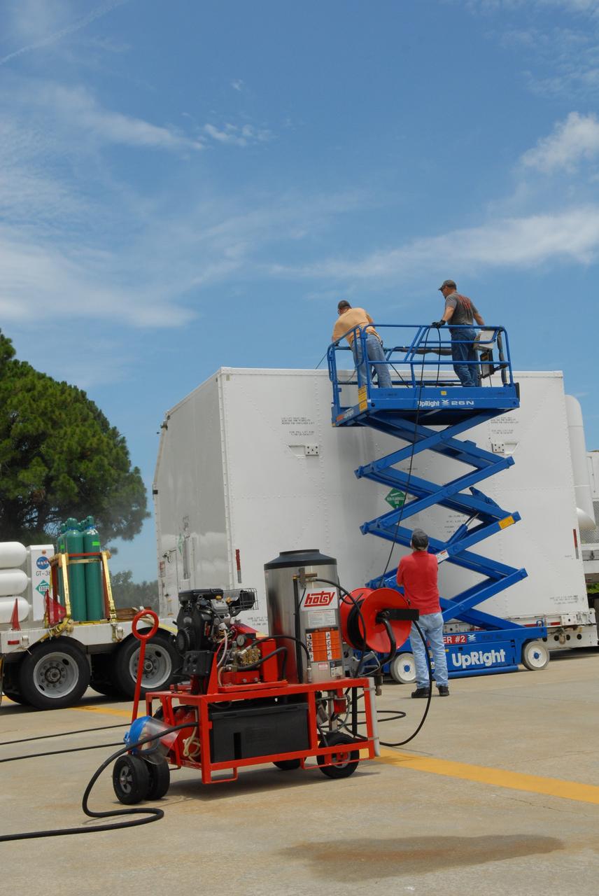 CAPE CANAVERAL, Fla. –  At the Canister Rotation Facility at NASA's Kennedy Space Center, workers steam clean the shipping containers holding the first major flight hardware for space shuttle Atlantis' STS-125 mission to NASA's Hubble Space Telescope.  The containers will next be moved to the airlock in the Payload Hazardous Servicing facility where the hardware will be prepared for its targeted October launch. The payload carriers will be prepared for the integration of telescope science instruments, both internal and external replacement components, as well as the flight support equipment to be used by the astronauts during the servicing mission.  The three payload carriers or pallets are the Flight Support System, the Super Lightweight Interchangeable Carrier and the Orbital Replacement Unit Carrier.  At the end of July, a fourth and final carrier, the Multi-Use Lightweight Equipment carrier will join the others in the Payload Hazardous Servicing Facility where the Hubble payload is being prepared for launch. Photo credit: NASA/Jack Pfaller