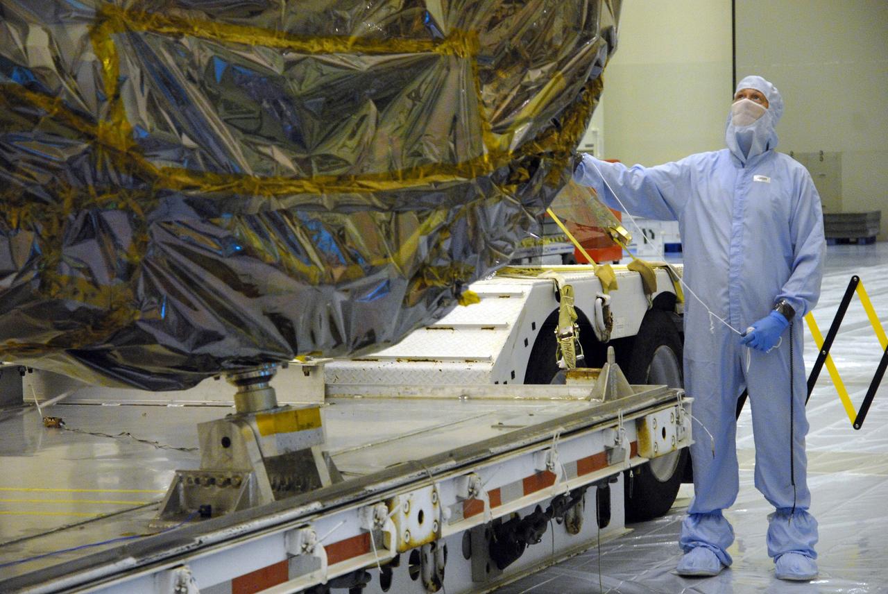 CAPE CANAVERAL, Fla. –  In the Payload Hazardous Servicing Facility at NASA's Kennedy Space Center, an overhead crane lifts the newly arrived ground support equipment for the STS-125 Hubble Servicing Mission off its transporter.  The GSE are carriers, or pallets, that will hold equipment in space shuttle Atlantis’ payload bay.  Under the protective covering of the carrier can be seen the soft capture mechanism. This carrier will be moved to a work stand.  The carriers will be prepared for the integration of telescope science instruments, both internal and external replacement components, as well as the flight support equipment to be used by the astronauts during the servicing mission.  The three payload carriers or pallets are the Flight Support System, the Super Lightweight Interchangeable Carrier and the Orbital Replacement Unit Carrier.  At the end of July, a fourth and final carrier, the Multi-Use Lightweight Equipment carrier will join the others in the Payload Hazardous Servicing Facility where the Hubble payload is being prepared for launch. Photo credit: NASA/Cory Huston