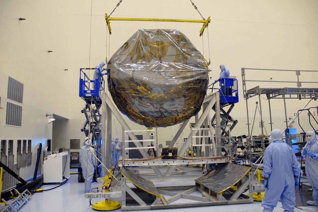 CAPE CANAVERAL, Fla. –  In the Payload Hazardous Servicing Facility at NASA's Kennedy Space Center, the overhead crane lifts the ground support equipment for the STS-125 Hubble Servicing Mission out of the thermal vacuum fixture.  The GSE are carriers, or pallets, that will hold equipment in space shuttle Atlantis’ payload bay.  Under the protective covering of the carrier can be seen the soft capture mechanism.  The carriers will be prepared for the integration of telescope science instruments, both internal and external replacement components, as well as the flight support equipment to be used by the astronauts during the servicing mission.  The three payload carriers or pallets are the Flight Support System, the Super Lightweight Interchangeable Carrier and the Orbital Replacement Unit Carrier.  At the end of July, a fourth and final carrier, the Multi-Use Lightweight Equipment carrier will join the others in the Payload Hazardous Servicing Facility where the Hubble payload is being prepared for launch. Photo credit: NASA/Cory Huston