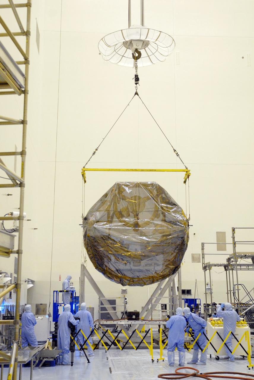 CAPE CANAVERAL, Fla. –  In the Payload Hazardous Servicing Facility at NASA's Kennedy Space Center, the overhead crane lifts the ground support equipment for the STS-125 Hubble Servicing Mission away from the thermal vacuum fixture.  The GSE are carriers, or pallets, that will hold equipment in space shuttle Atlantis’ payload bay.  Under the protective covering of the carrier can be seen the soft capture mechanism.  The carrier will be moved to a work stand. The carriers will be prepared for the integration of telescope science instruments, both internal and external replacement components, as well as the flight support equipment to be used by the astronauts during the servicing mission.  The three payload carriers or pallets are the Flight Support System, the Super Lightweight Interchangeable Carrier and the Orbital Replacement Unit Carrier.  At the end of July, a fourth and final carrier, the Multi-Use Lightweight Equipment carrier will join the others in the Payload Hazardous Servicing Facility where the Hubble payload is being prepared for launch. Photo credit: NASA/Cory Huston