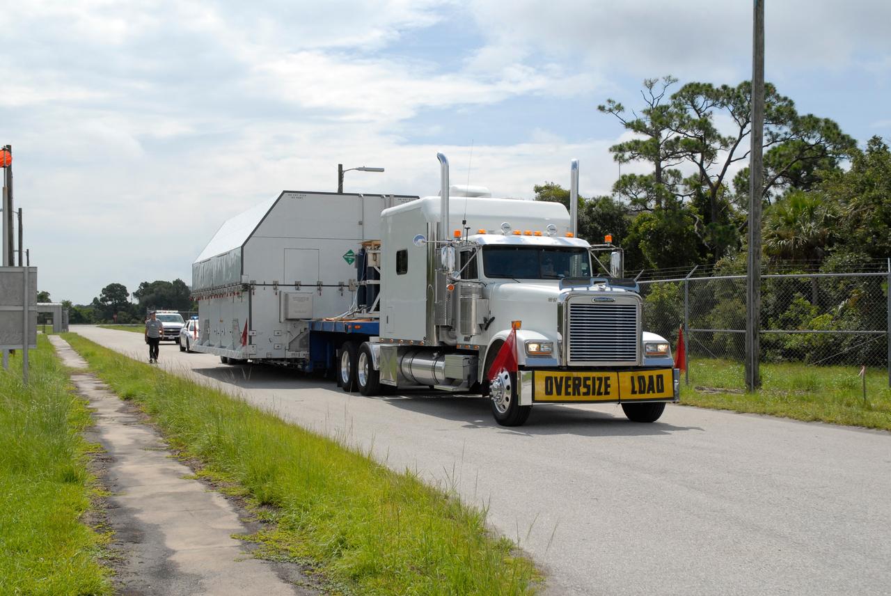 CAPE CANAVERAL, Fla. –  A second shipping container of major flight hardware for space shuttle Atlantis' STS-125 mission to NASA's Hubble Space Telescope is transported to the Payload Hazardous Servicing Facility at NASA's Kennedy Space Center to begin preparations for its targeted October launch.  The container holds the Super Lightweight Interchangeable Carrier, or SLIC, and the Orbital Replacement Unit Carrier, or ORUC. The payload carriers will be prepared for the integration of telescope science instruments, both internal and external replacement components, as well as the flight support equipment to be used by the astronauts during the servicing mission.  The three payload carriers or pallets are the Flight Support System, the SLIC and the ORUC.  At the end of July, a fourth and final carrier, the Multi-Use Lightweight Equipment carrier will join the others in the Payload Hazardous Servicing Facility where the Hubble payload is being prepared for launch. Photo credit: NASA/Amanda Diller